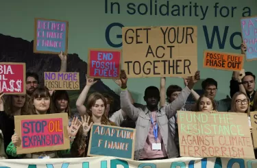 Young people holding climate protest signs