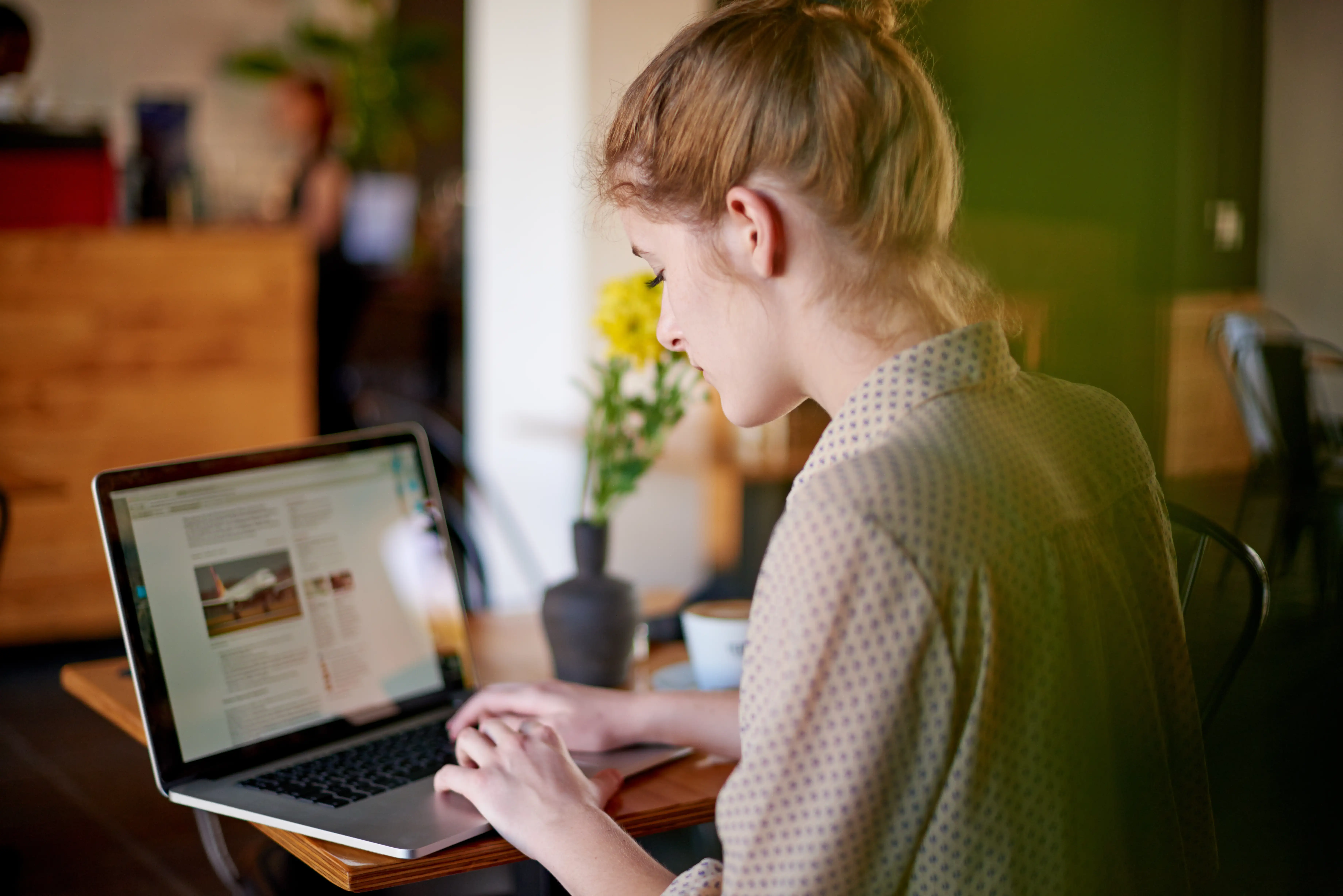 A woman writing on a laptop