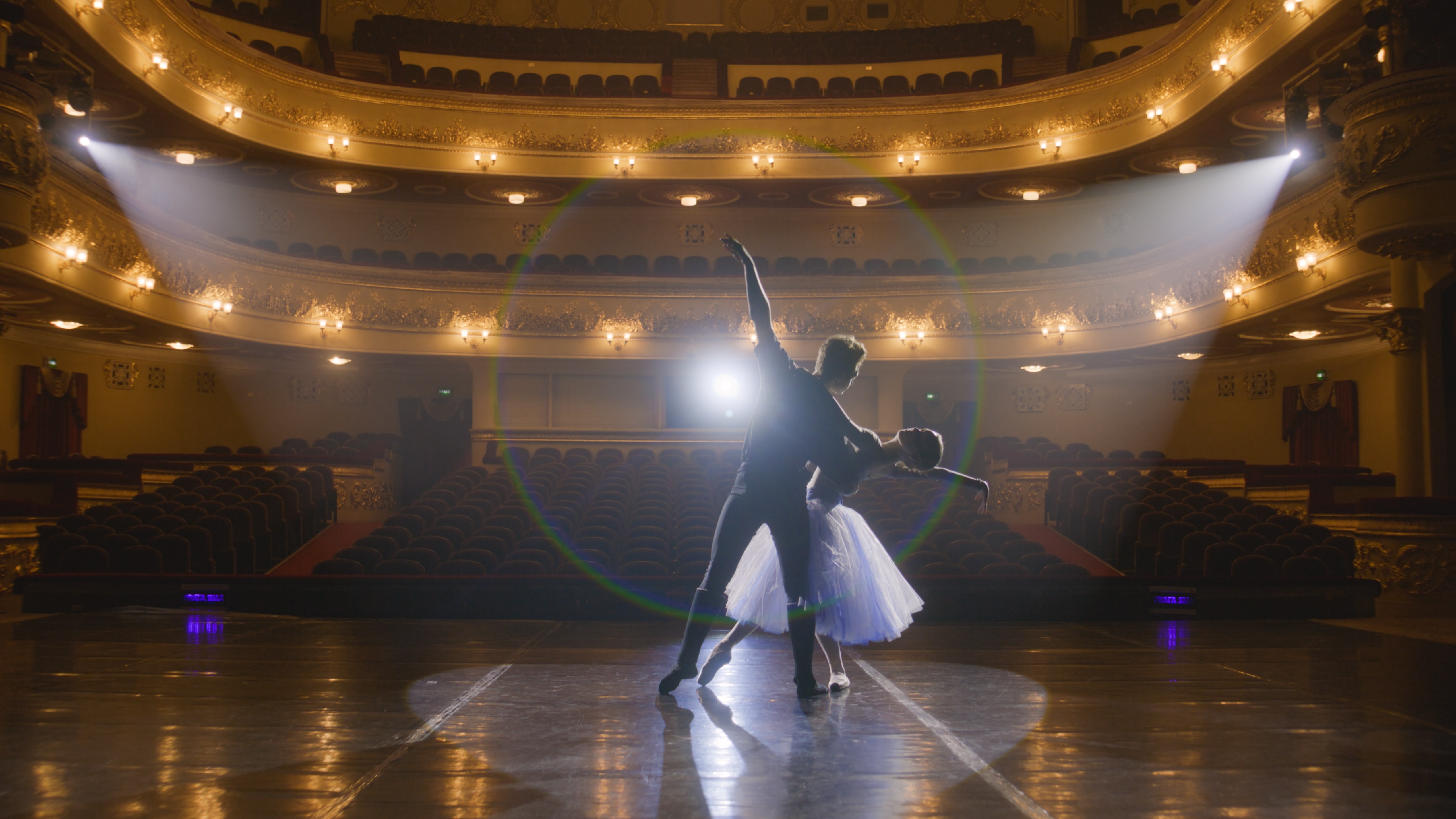 Dancers with empty theatre behind