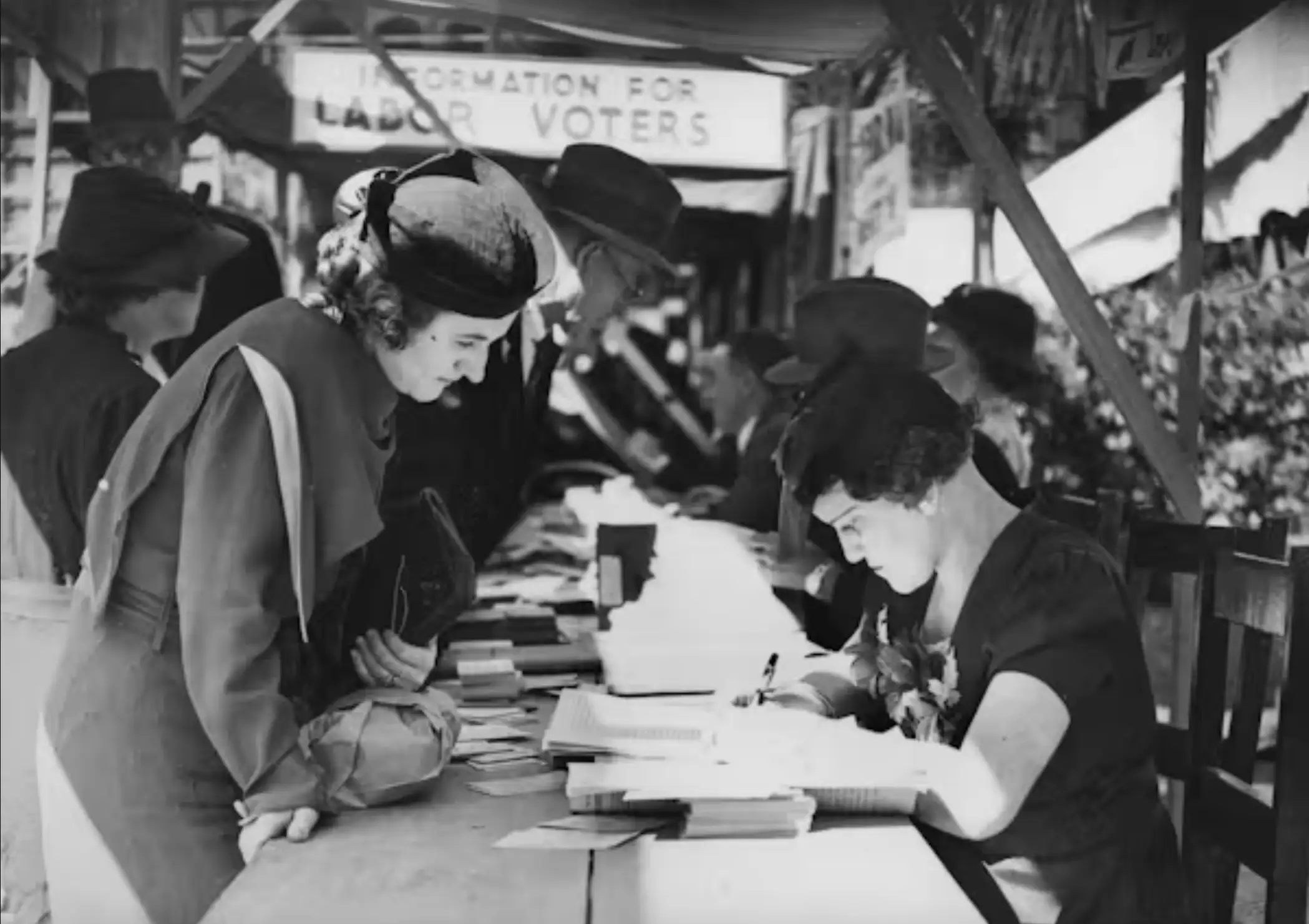 A black-and-white image of a woman voting