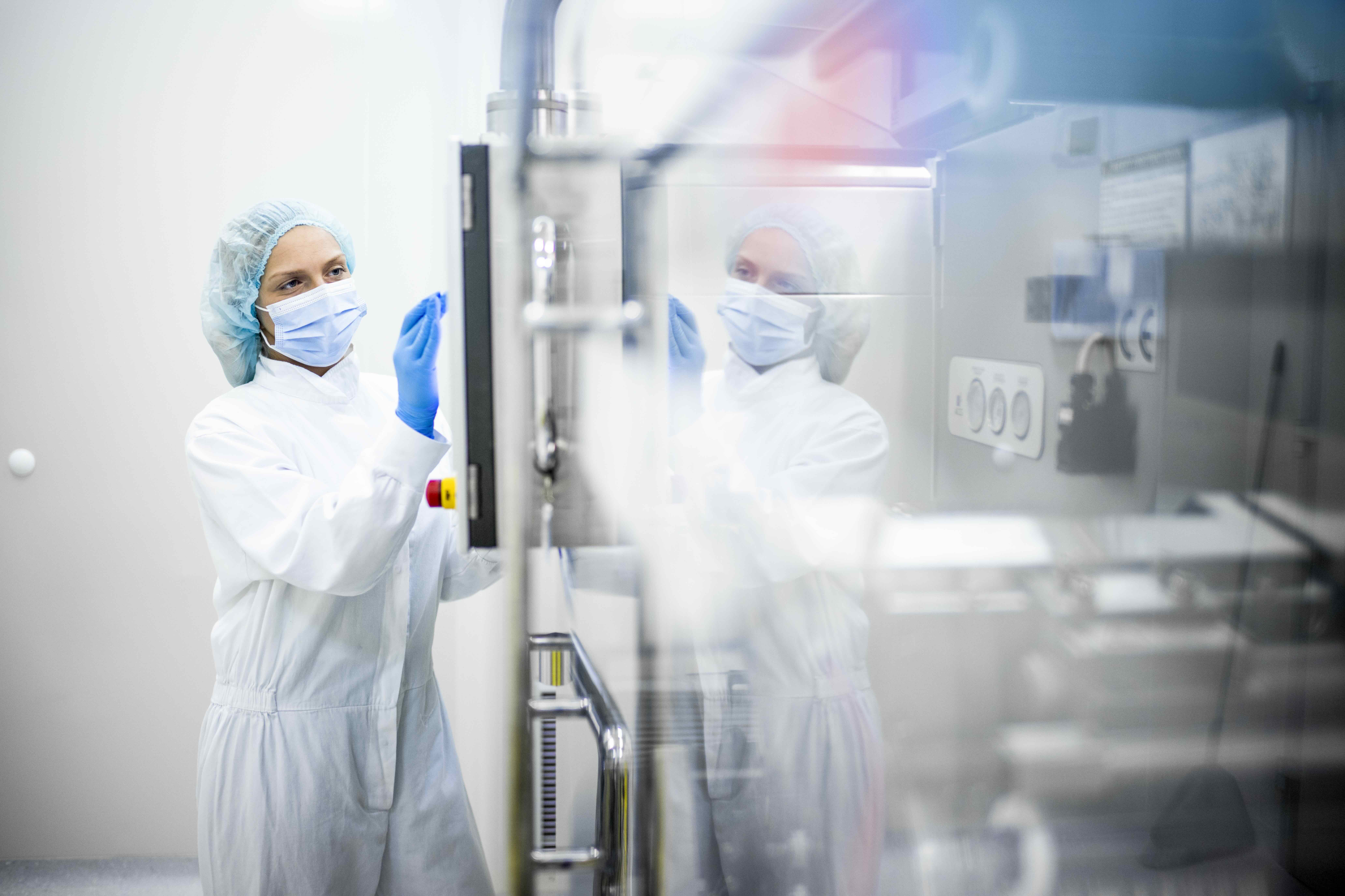 Woman Operating Pharmaceutical Machinery