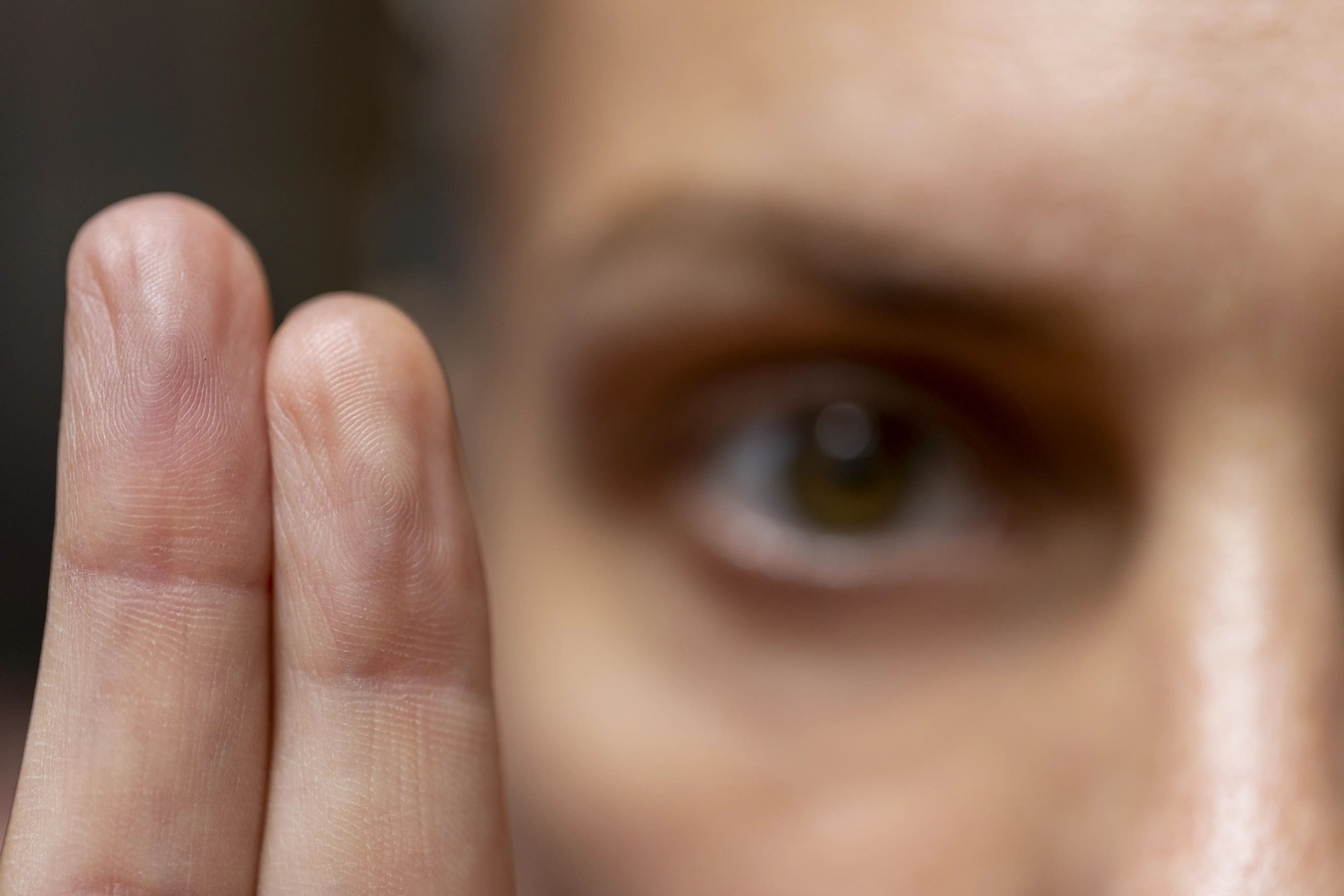 A close-up of an eye focused on fingers as part of EMDR therapy