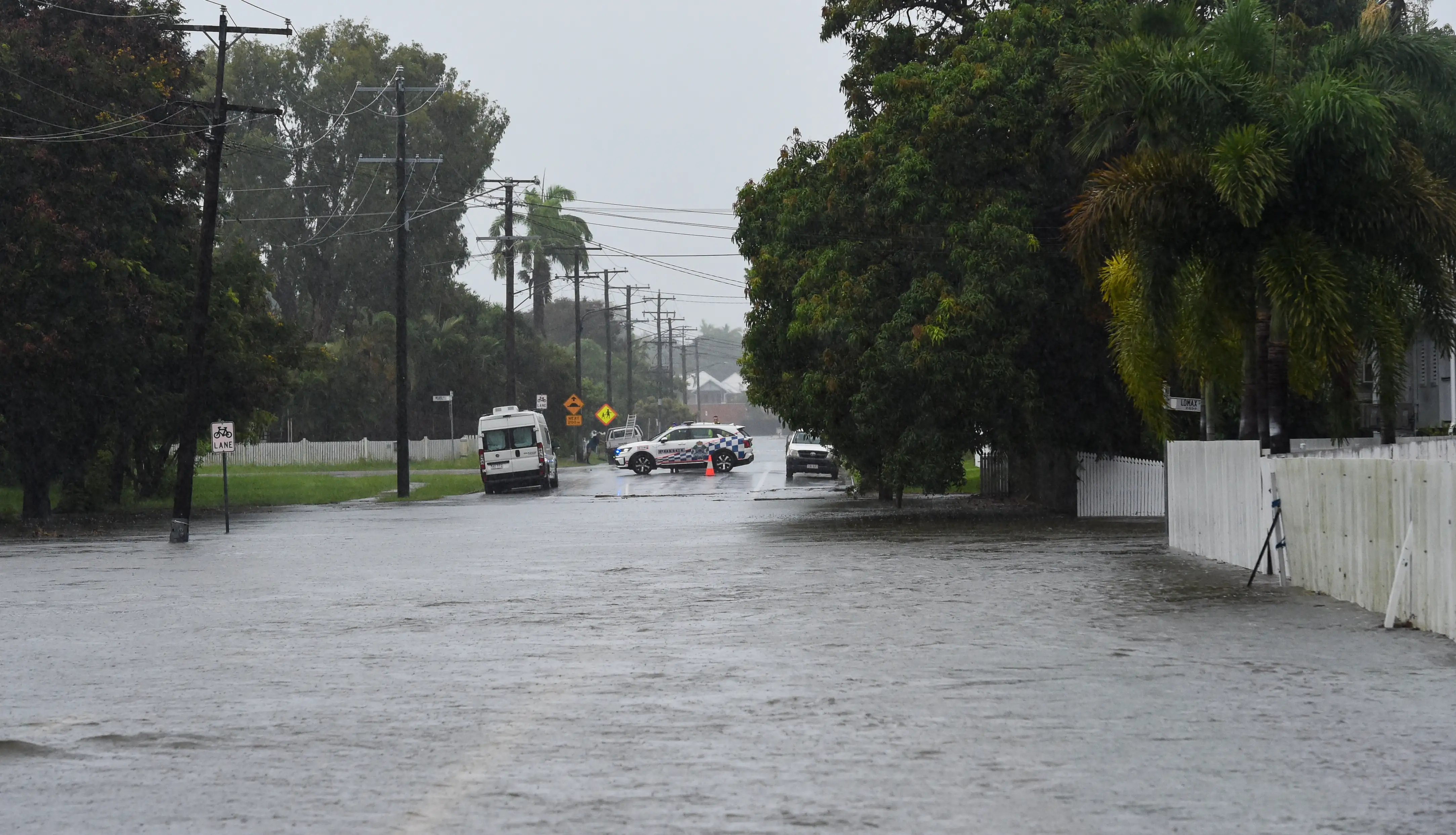 Floodwaters over a road blocked by a police car January 31, 2025. 