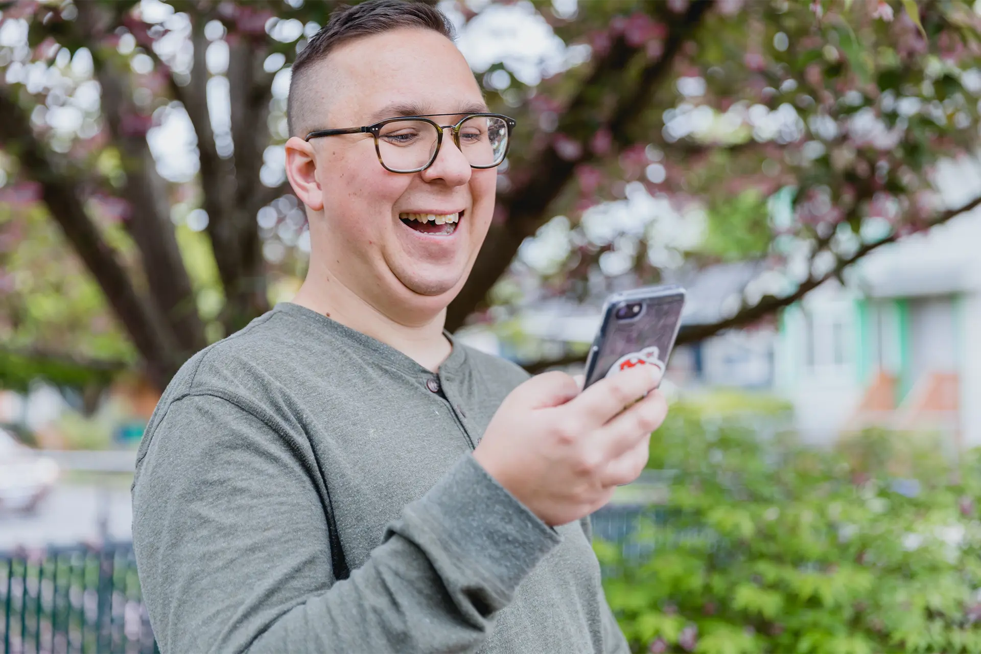 Man smiling and looking at phone