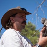 Headshot of Kristoffer Wild holding a lizard