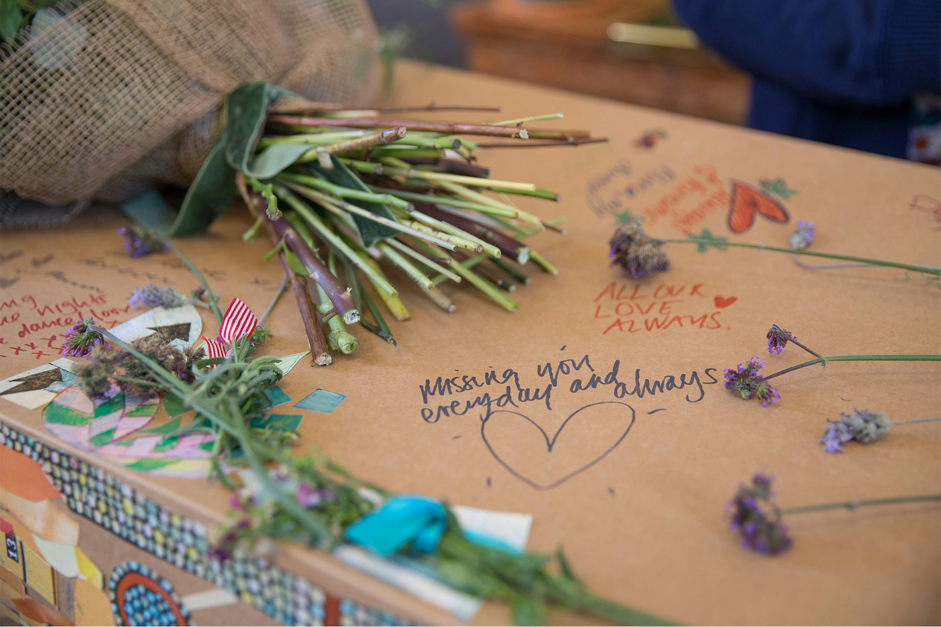 Flowers and writing on a cardboard coffin