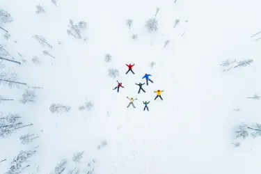 A family making 'snow angels' in Finland