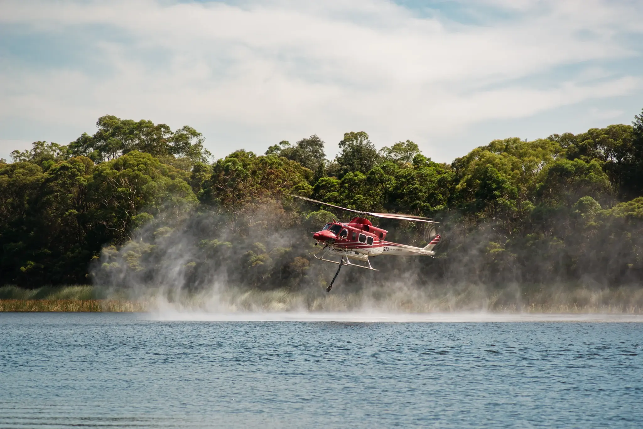 A fire-fighting helicopter collecting water