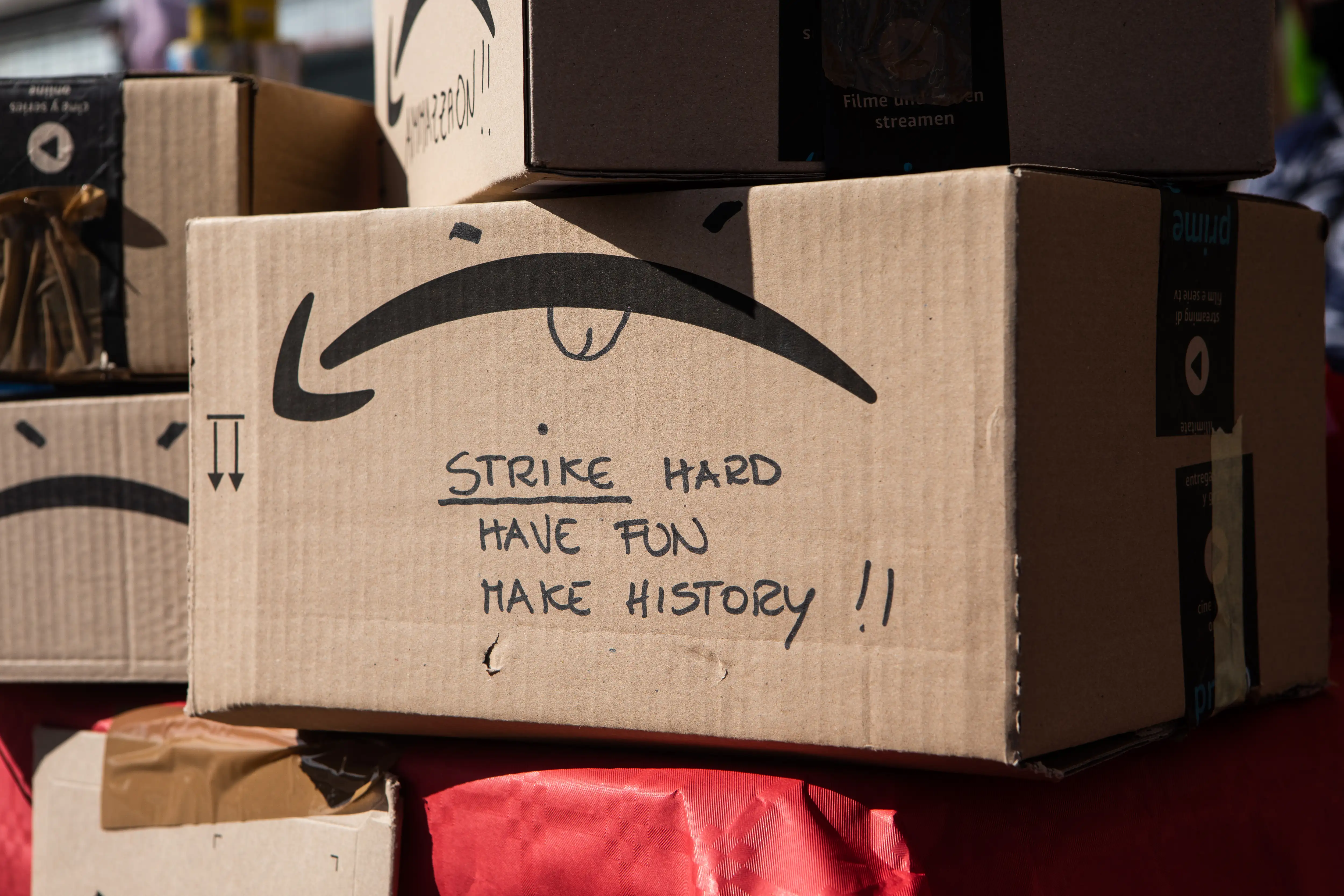 An Amazon parcel with a handwritten note reading "Strike hard, have fun, make history"