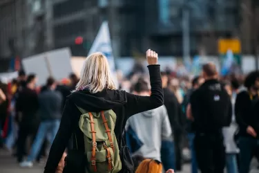 Young woman at protest with fist raised