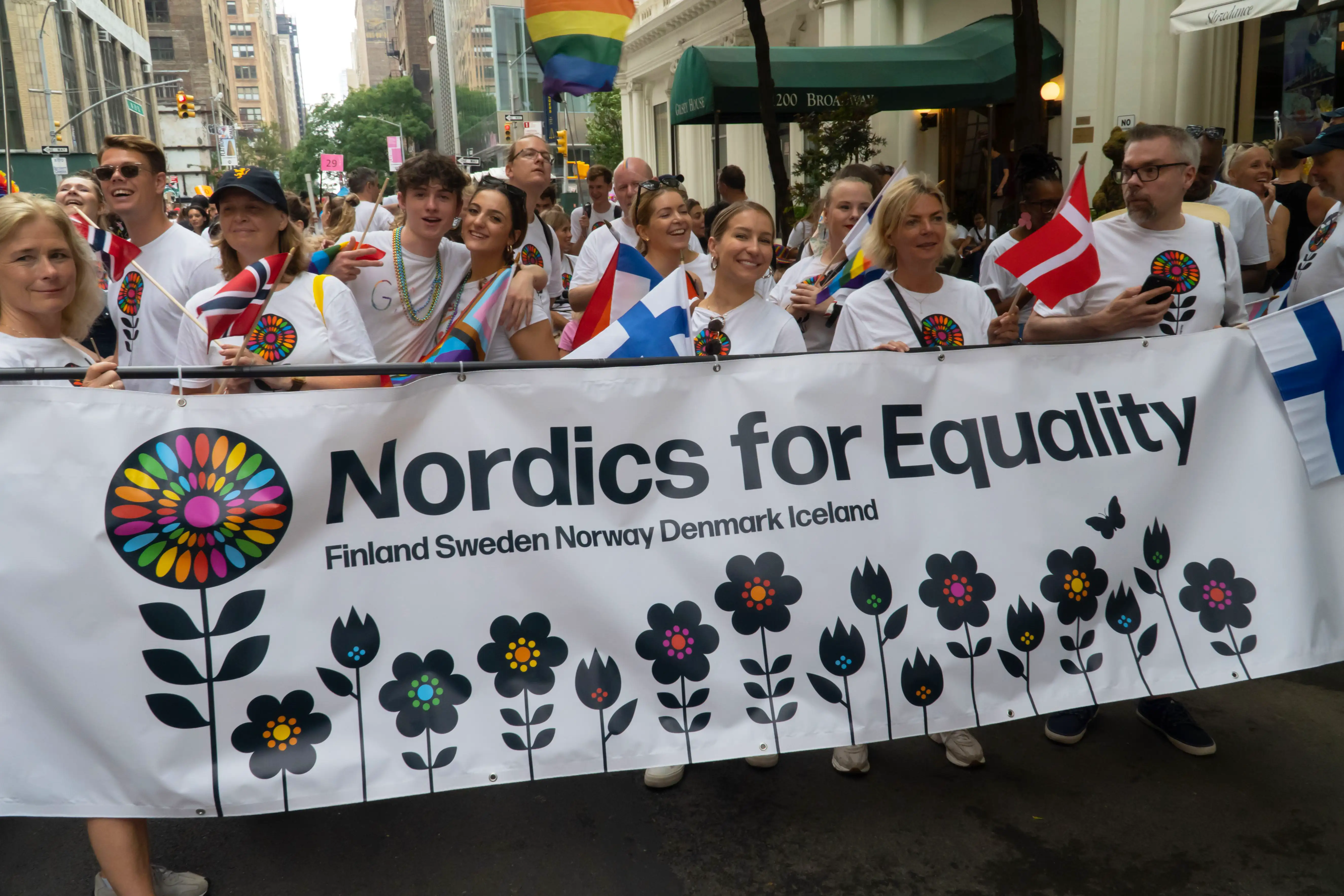 Members of the Nordics for Equality delegation display their rainbow-colored, flower themed banner, ahead of a pride march.
