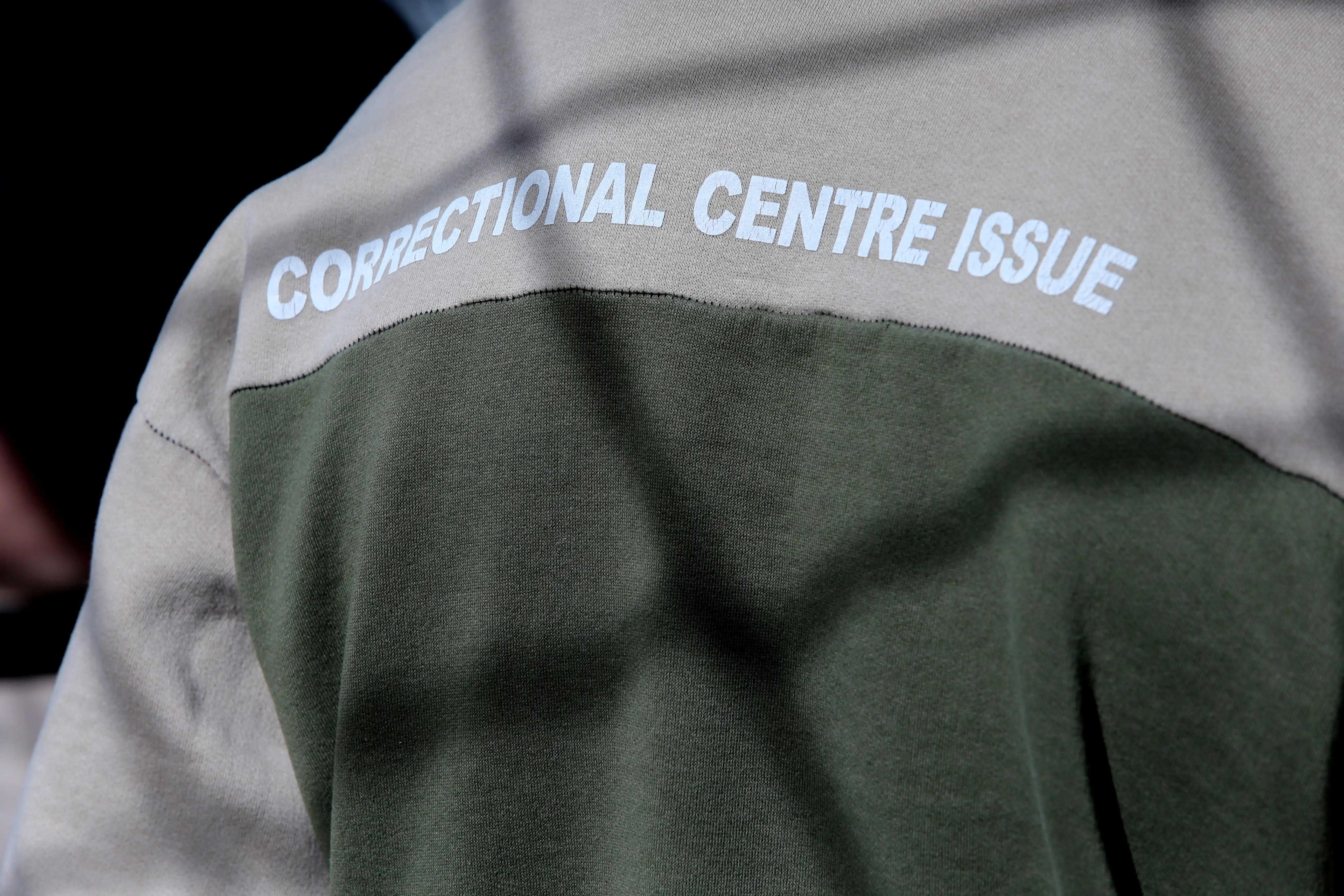 An anonymous prisoner wearing a correction centre uniform 