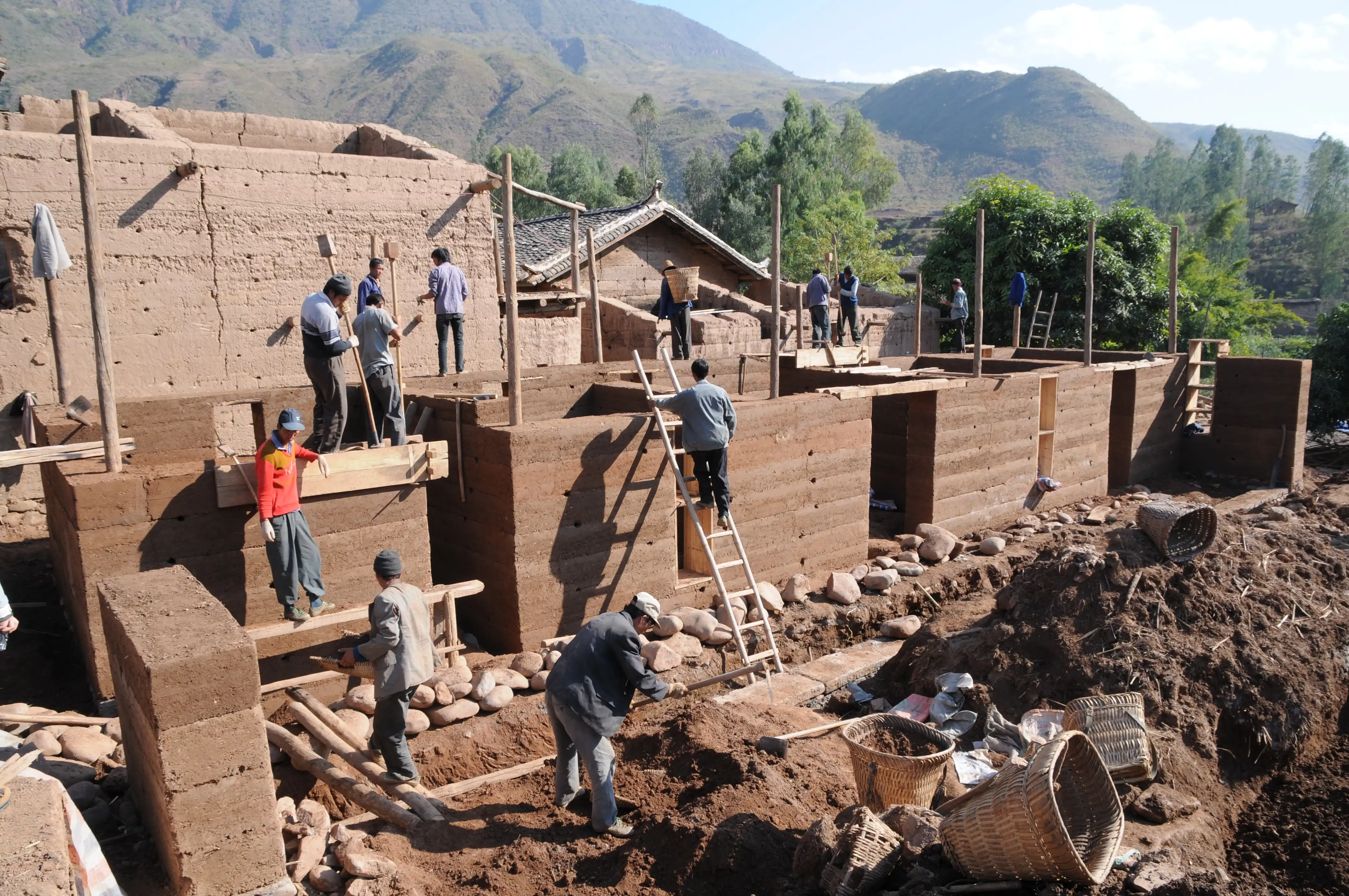 A team reconstructing a village used rammed earth for walls