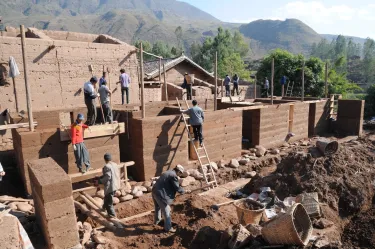 A team reconstructing a village used rammed earth for walls