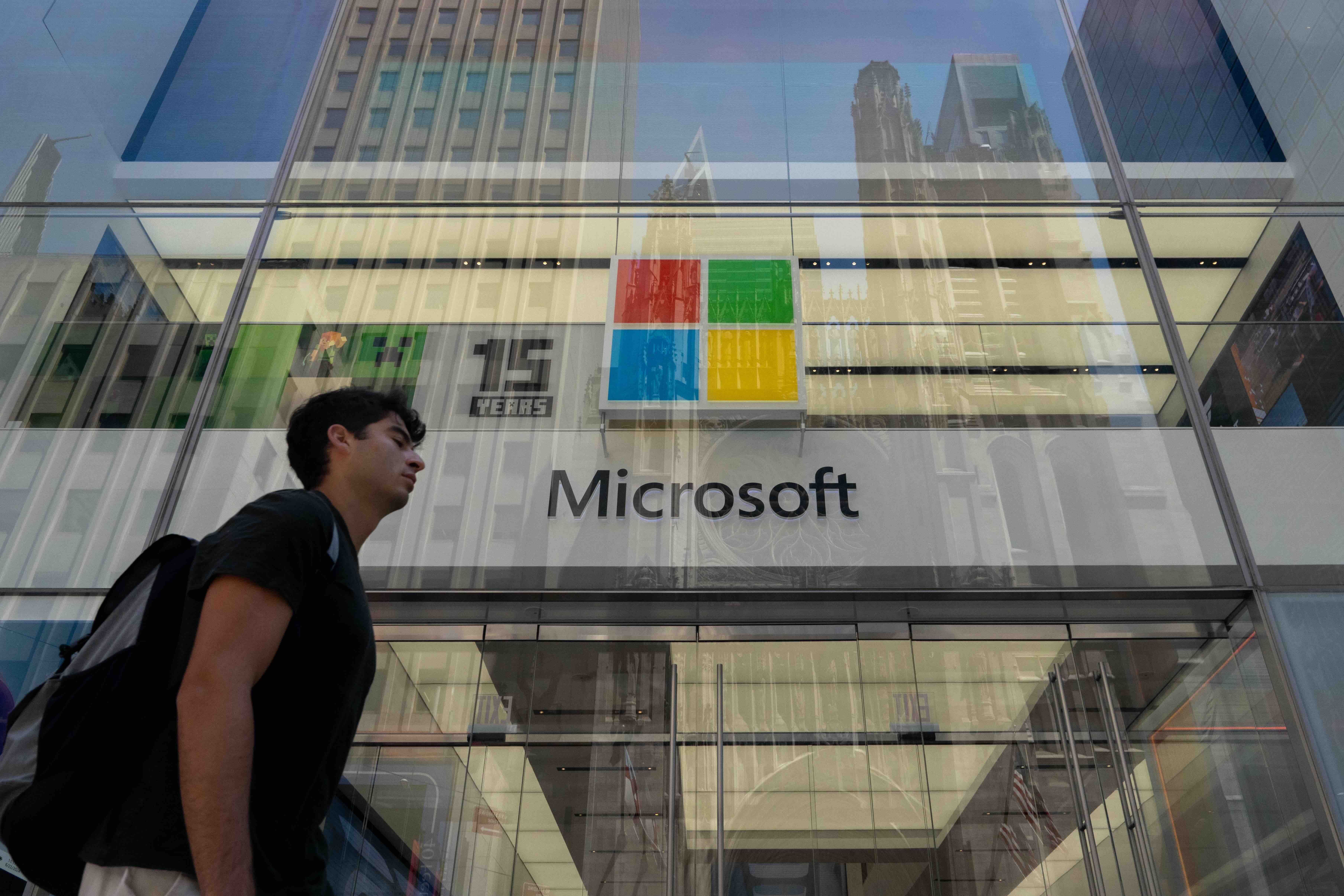 People walk past the Microsoft store in New York