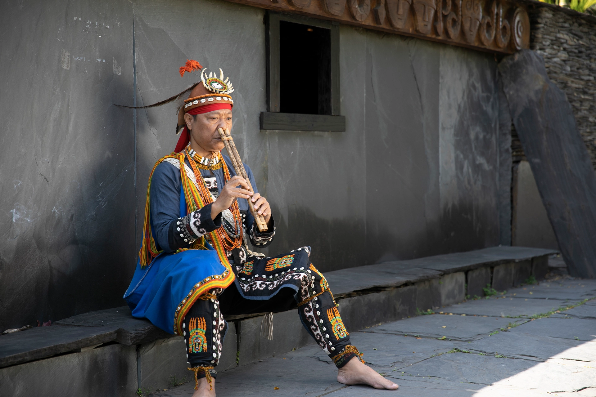 Man playing nose flute in an Paiwanese village