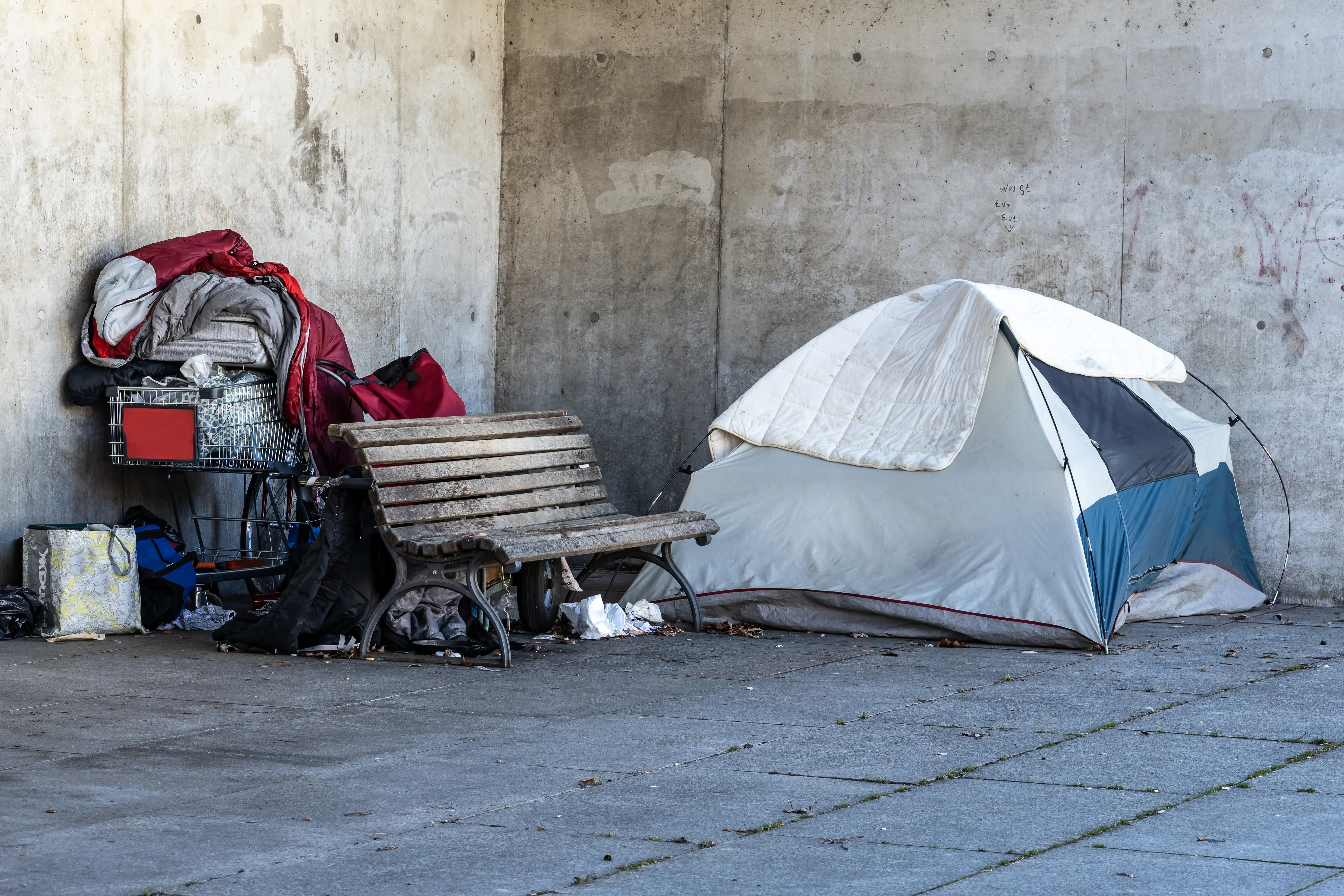 A tent put up on the side of the a busy street