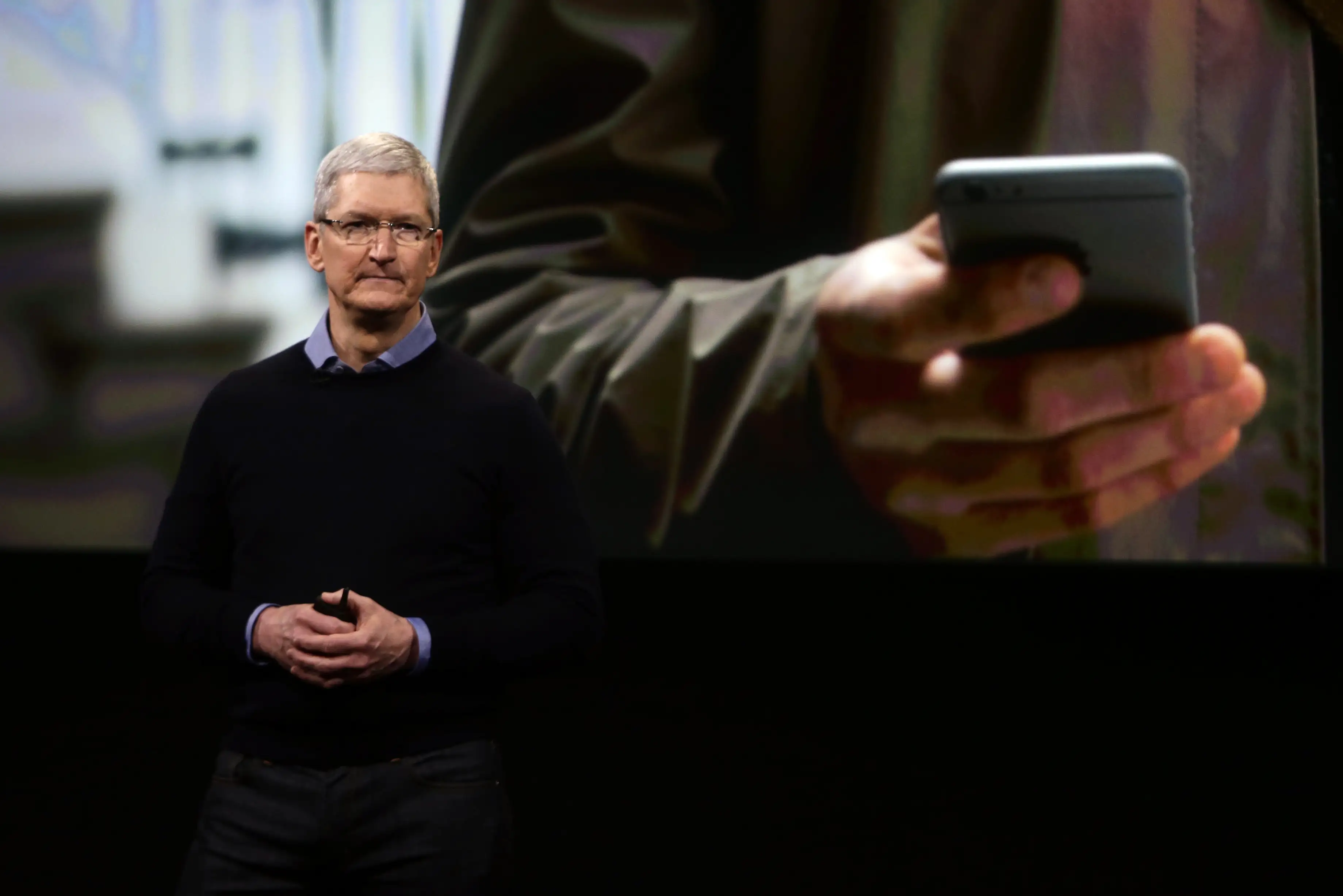 Apple CEO Tim Cook presenting on stage during a product launch in 2016