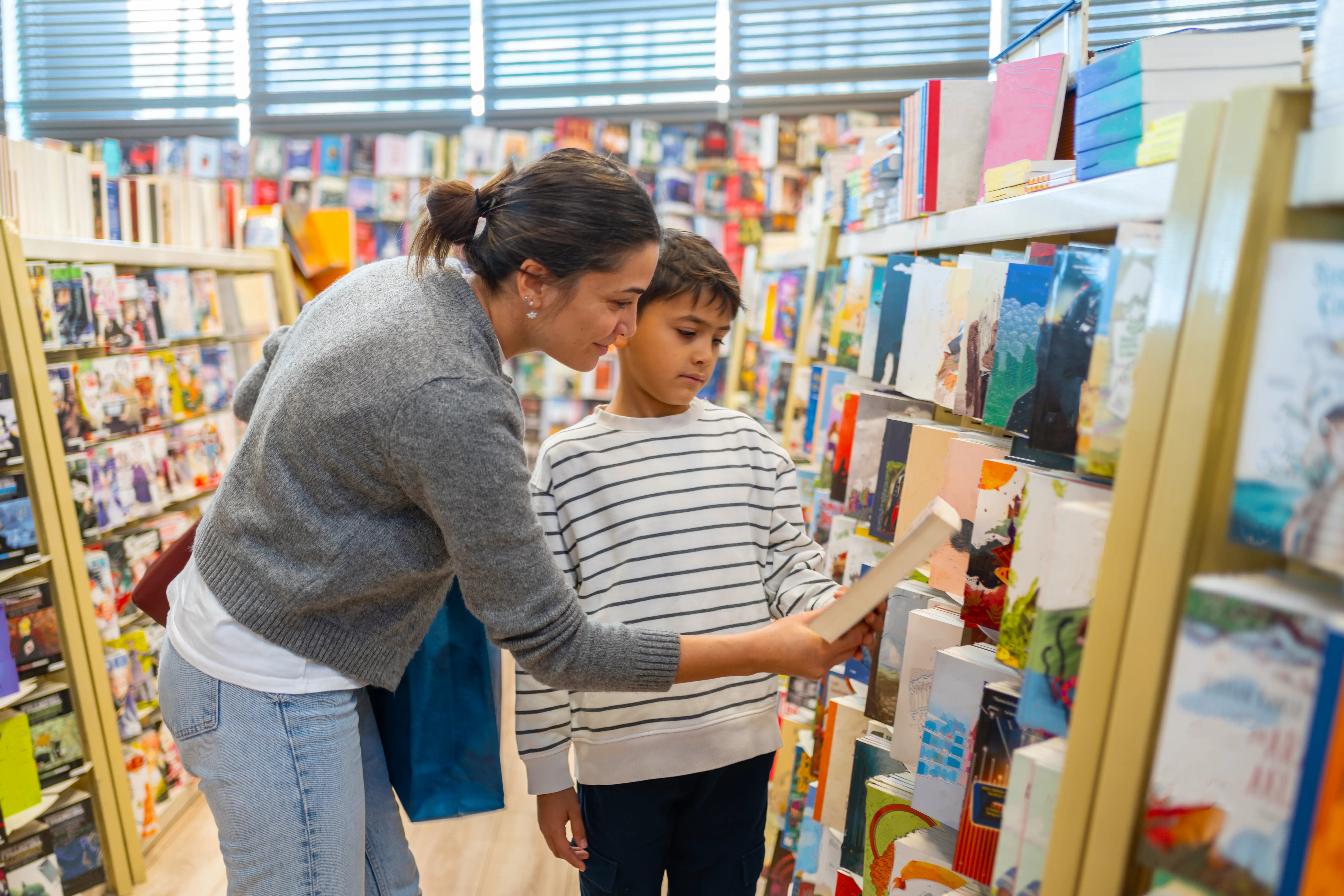 A mother and son shopping in a bookstore
