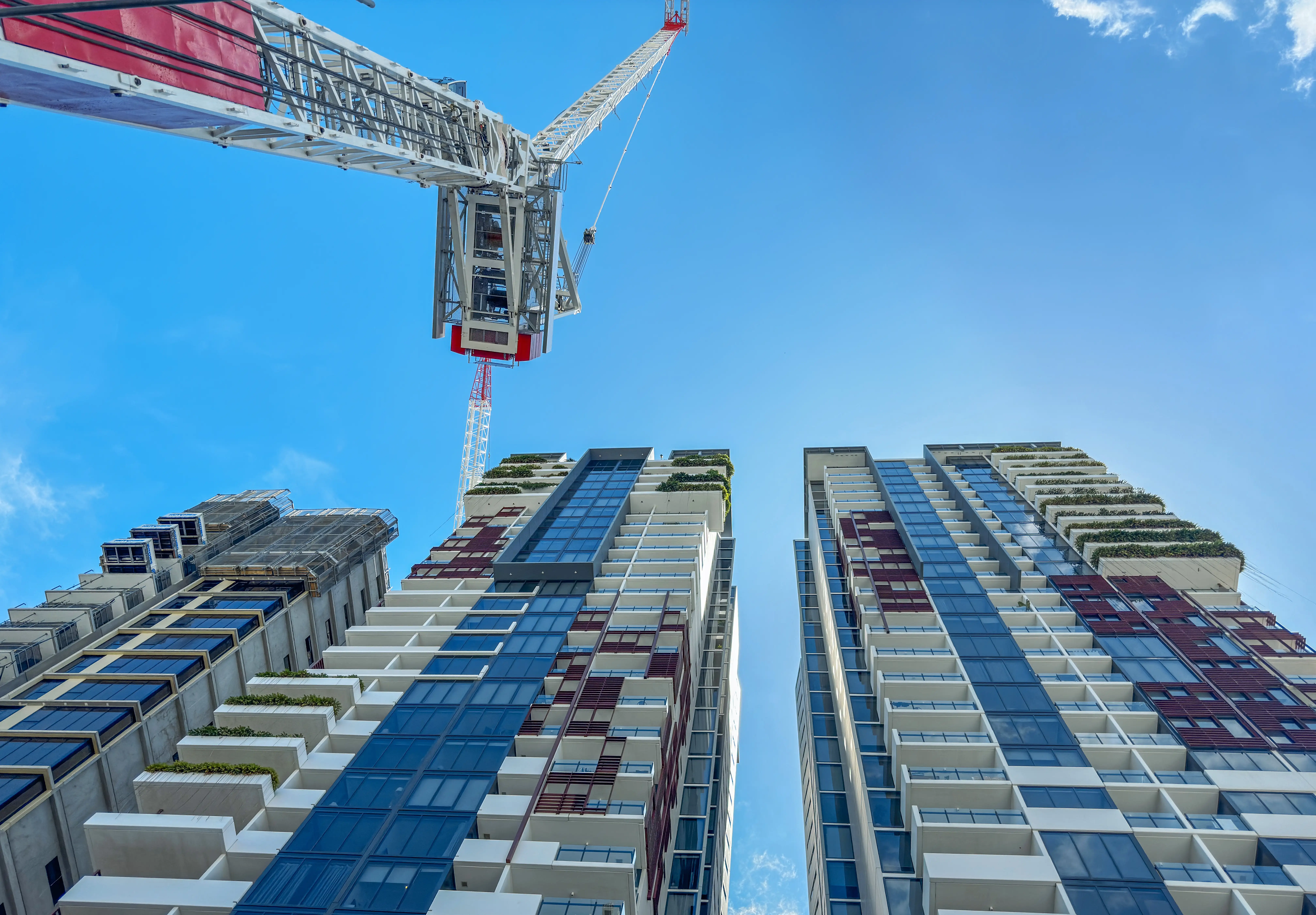 Workers install a window at a construction site in New South Wales