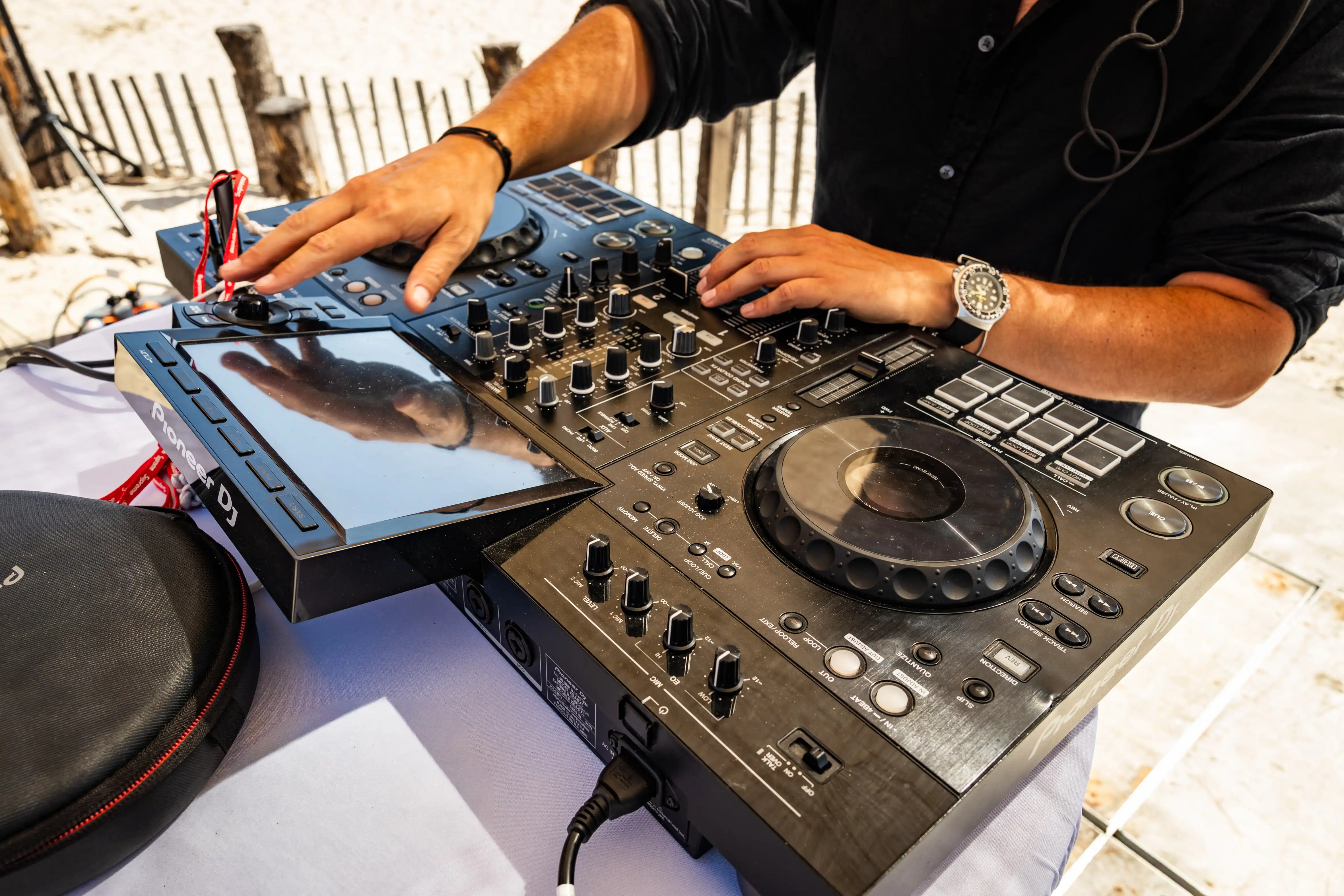 A close up of dj decks with a person mixing music