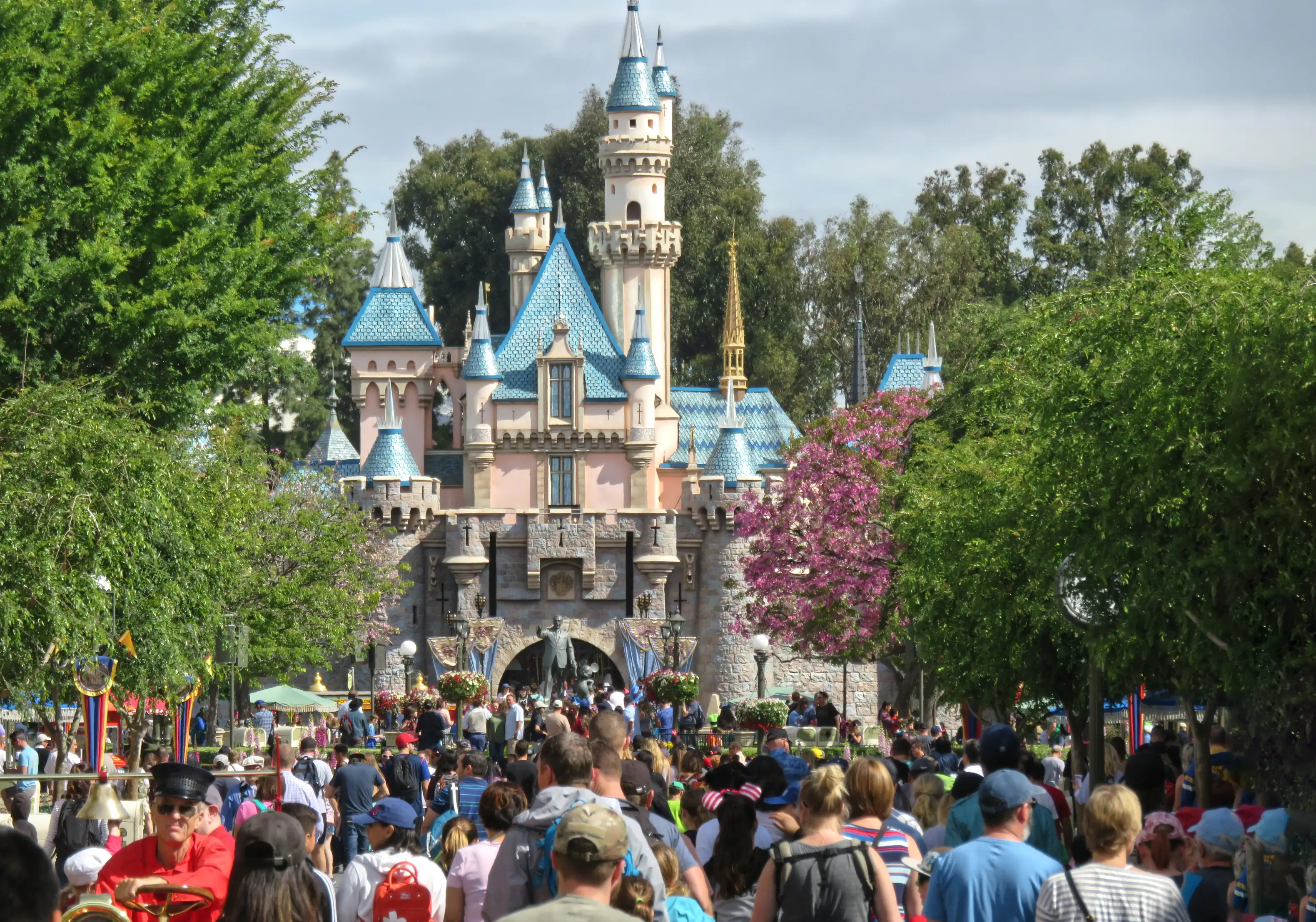 A crowd walking into Disneyland