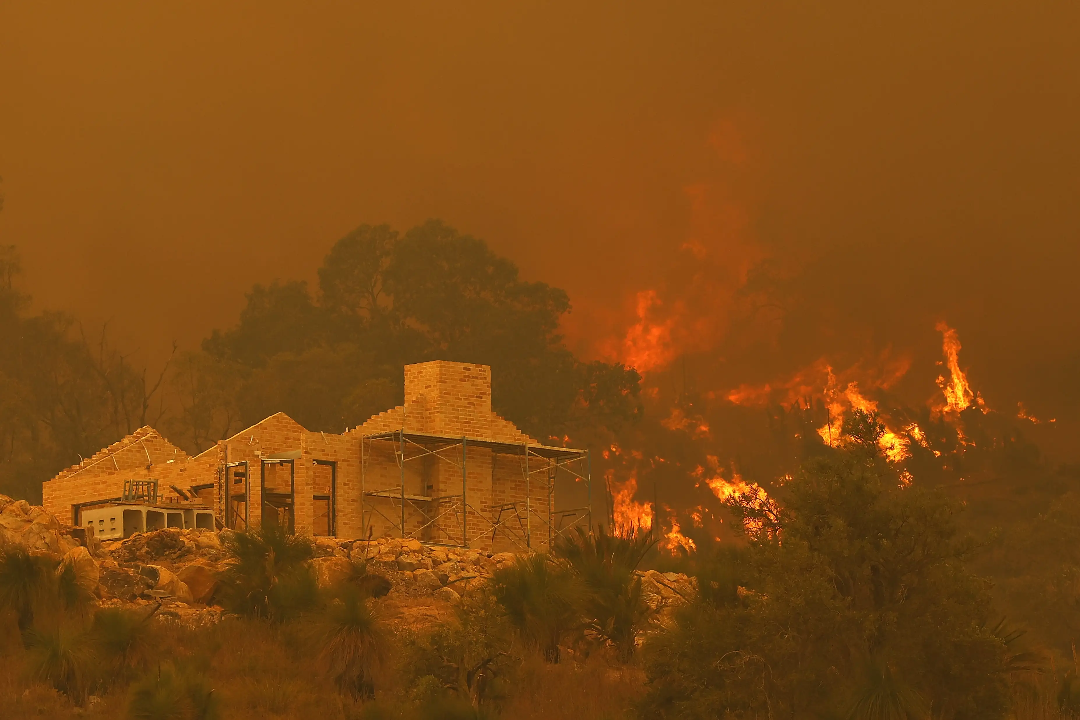 Flames surround a property under construction 