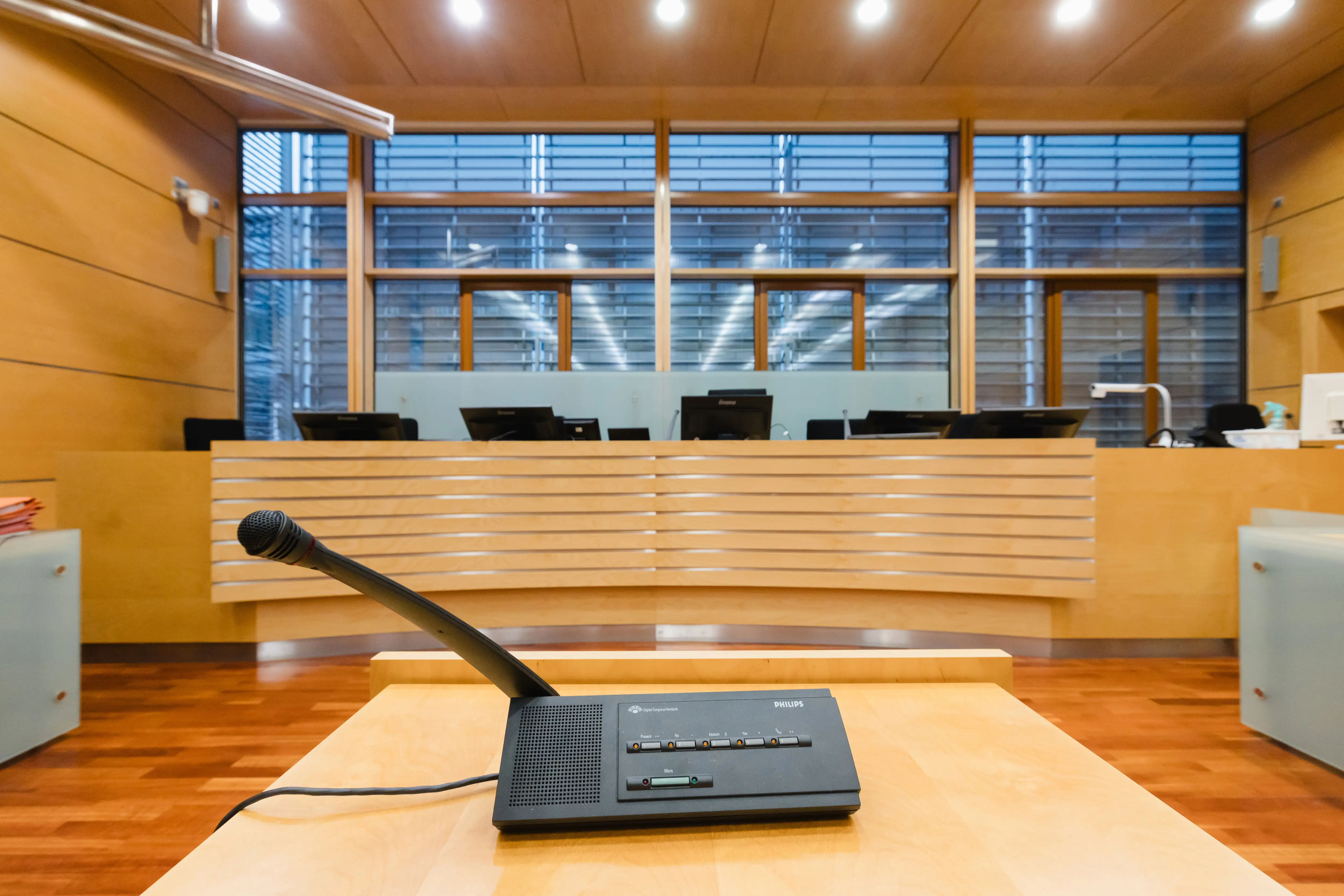A microphone in a witness box inside a courtroom