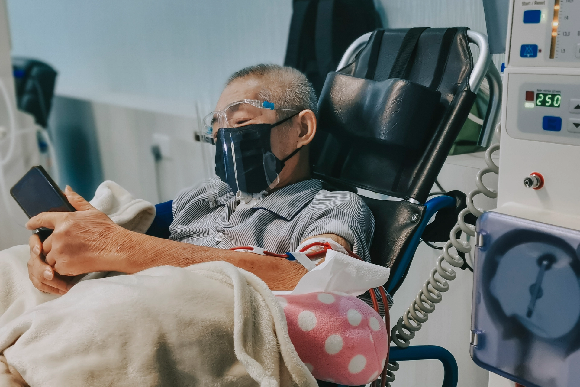 Elderly man in a dialysis chair in hospital