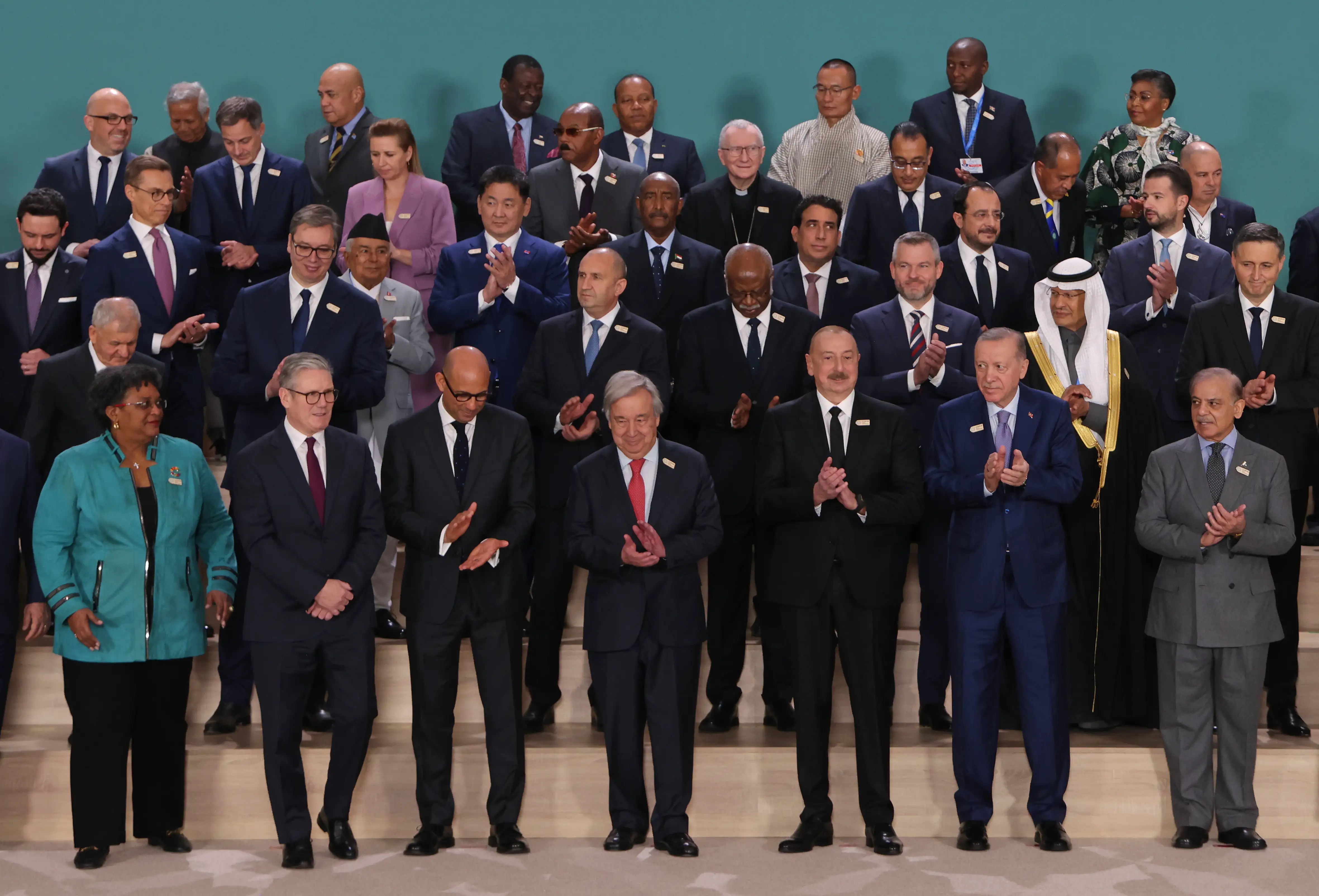 World leaders applaud after posing for a family photo on day two at the UNFCCC COP29 Climate Conference