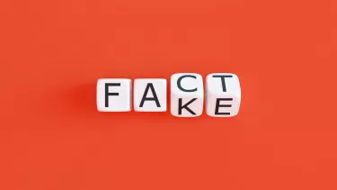 Fact and fake spelled out on a red background