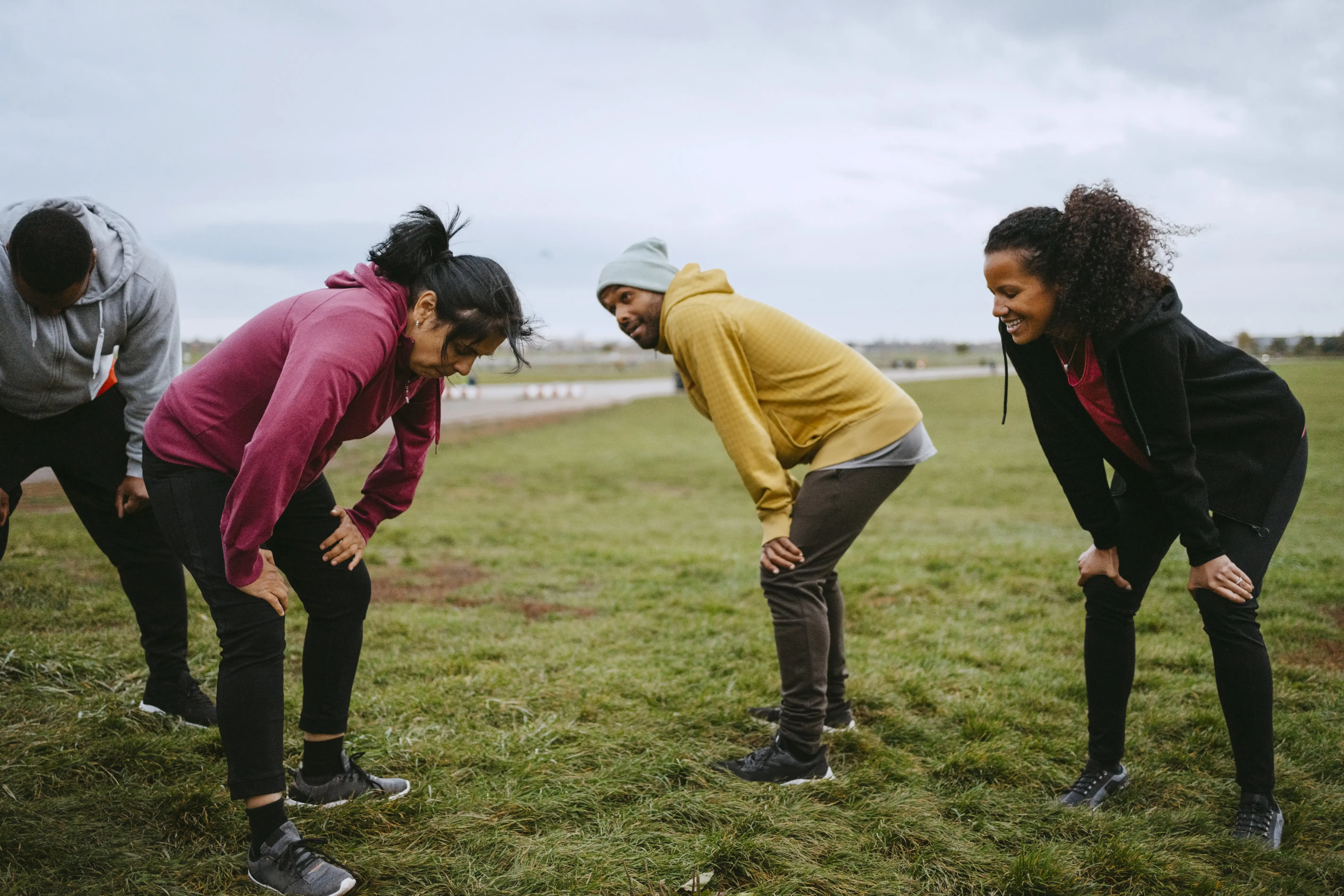 Group of older people recovering from exercise in a park