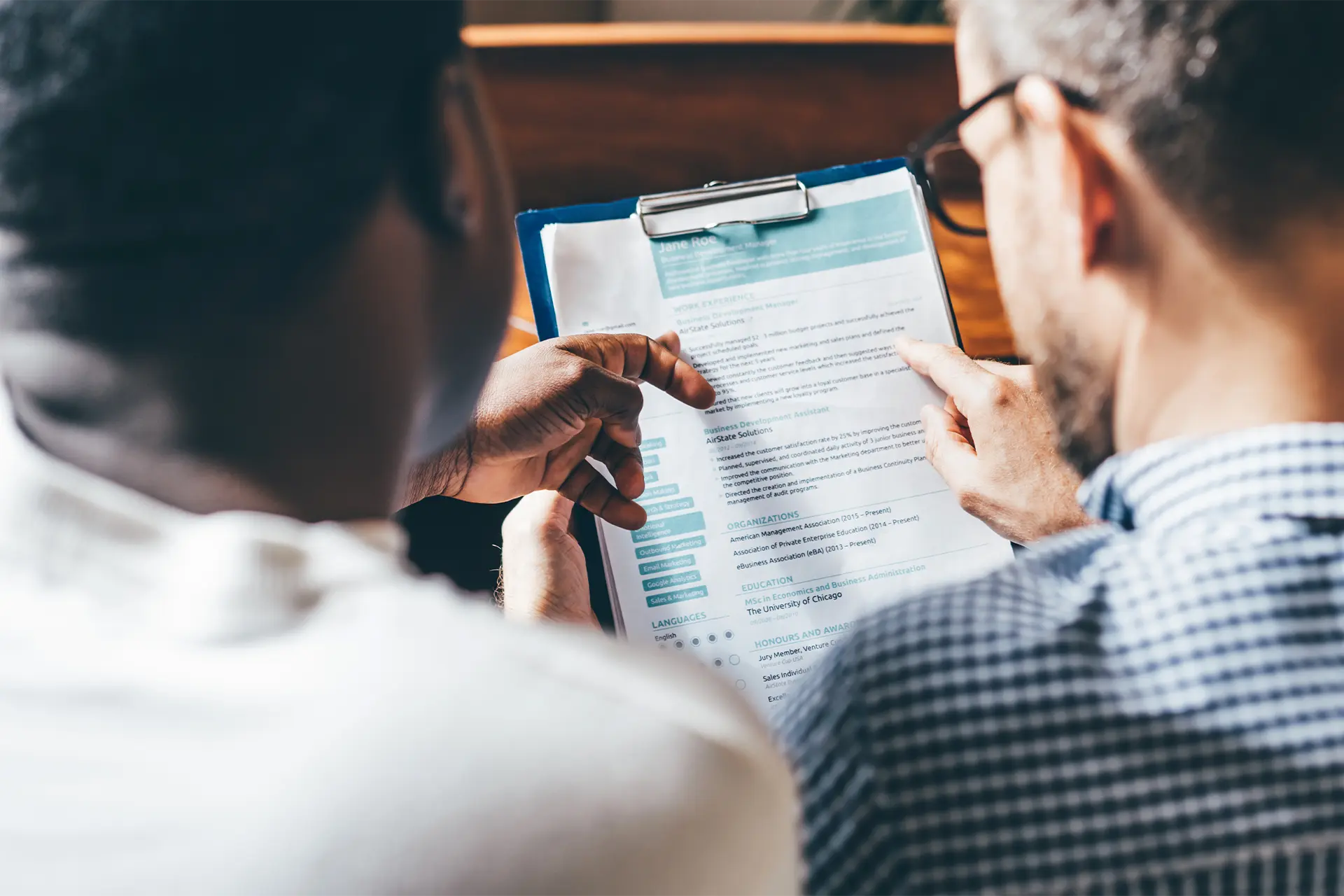 Two men filling in a paper form
