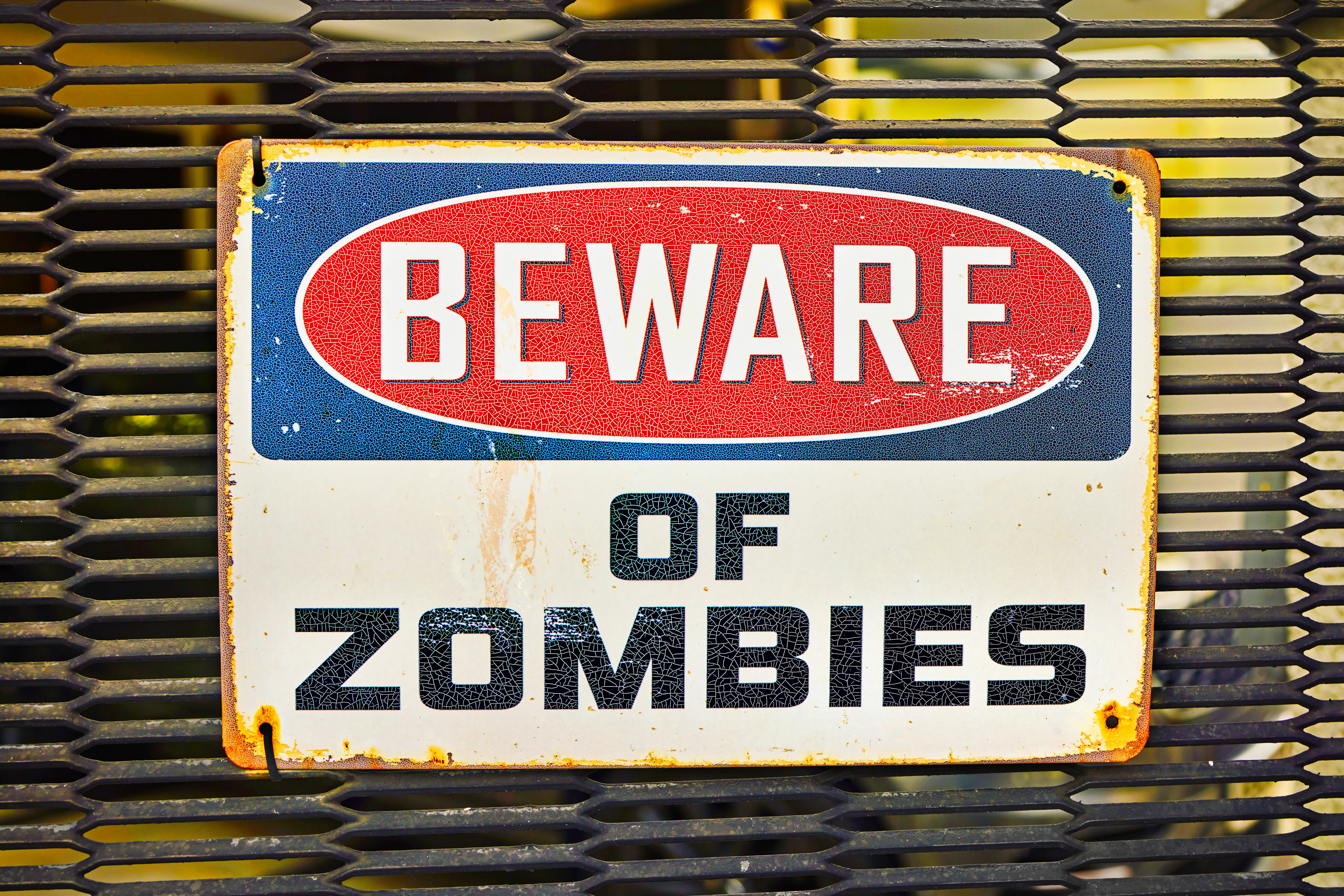 Beware of zombies sign on metal gate