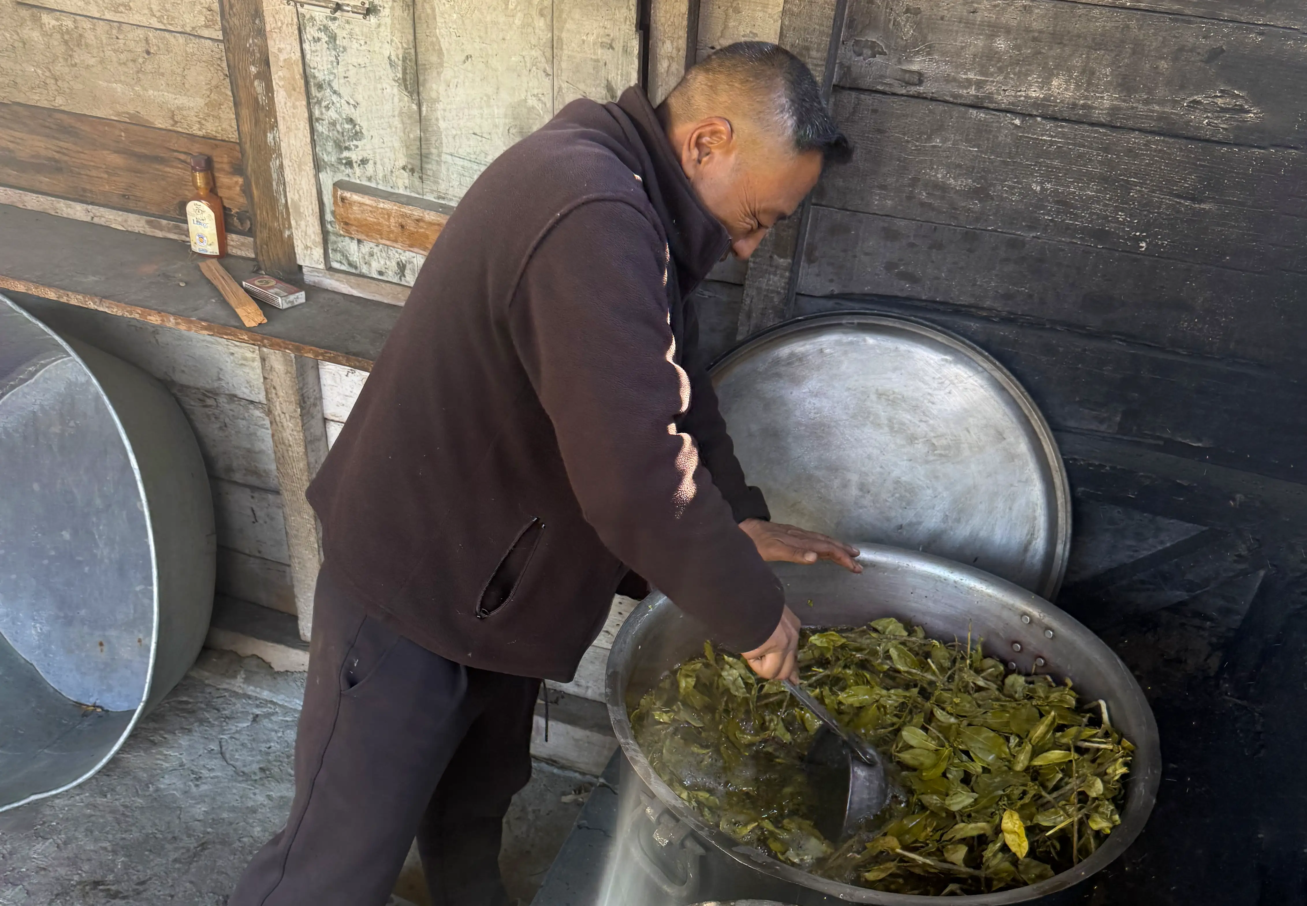 Kencho boiling leaves at his Bhutanese dyeing centre