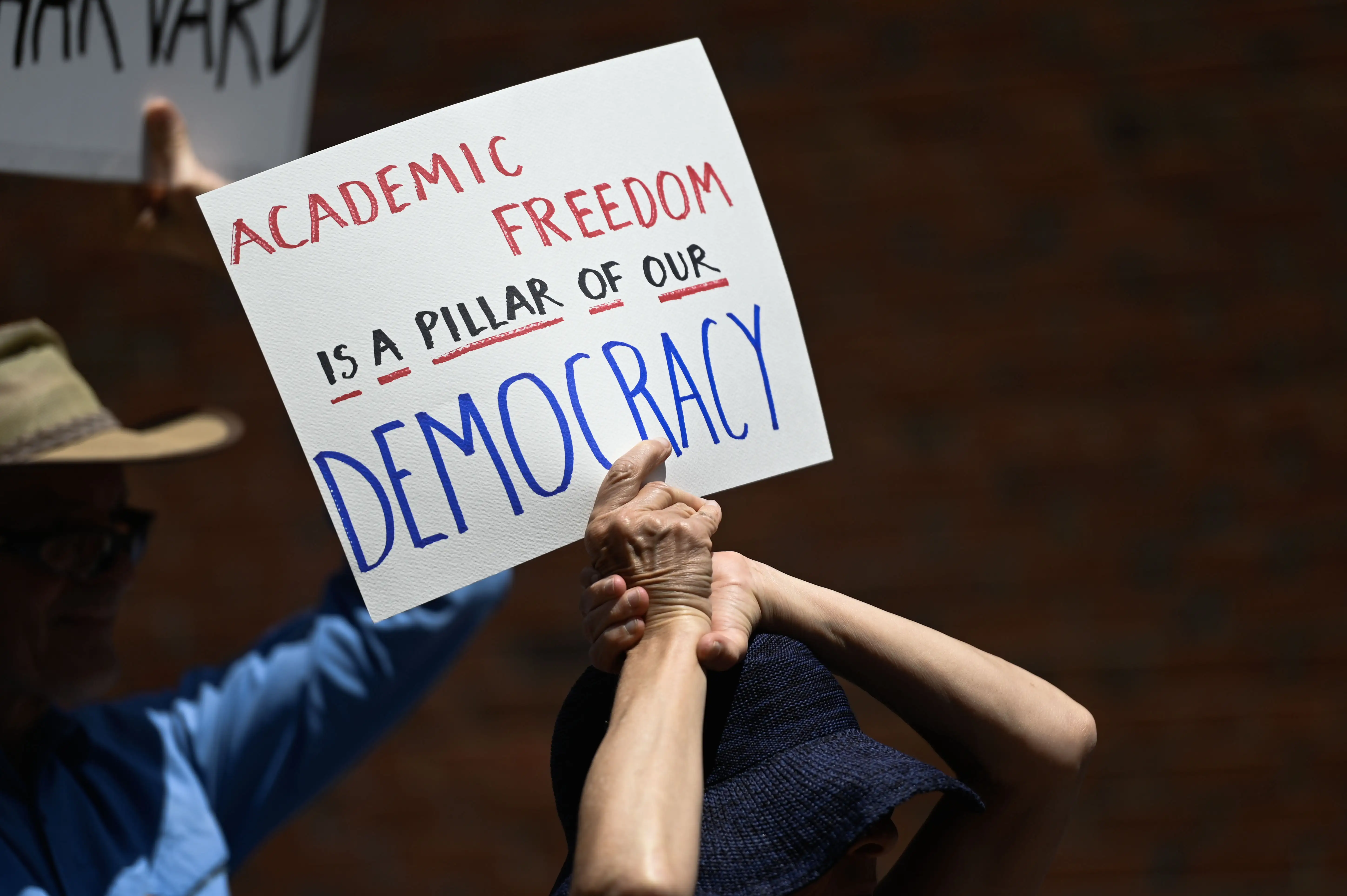 Harvard alumni, students and faculty protest the federal administration cuts