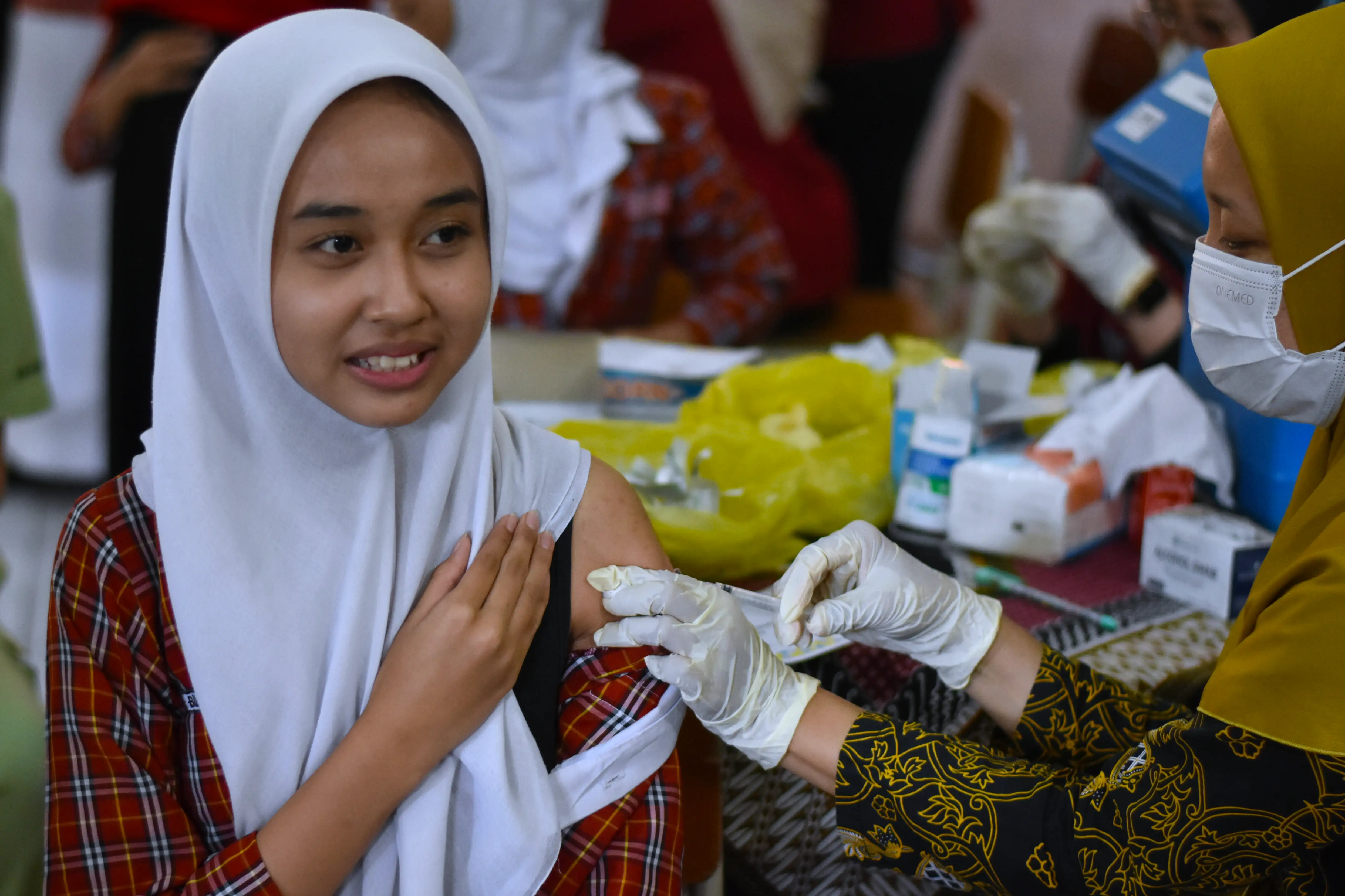 A high school student receives an HPV (Human Papillomavirus) vaccine injection in Indonesia