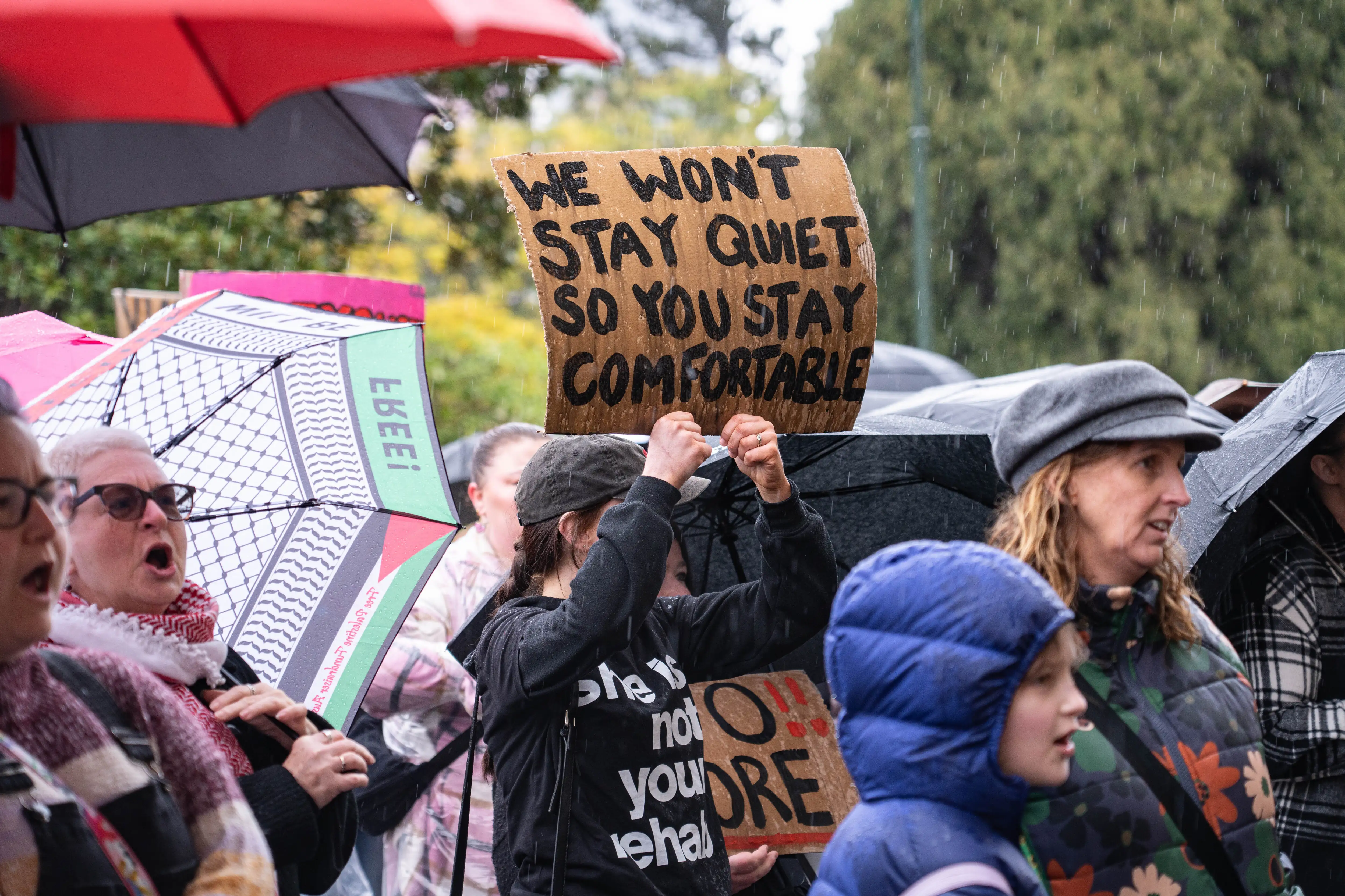 A protester holds a placard that says 