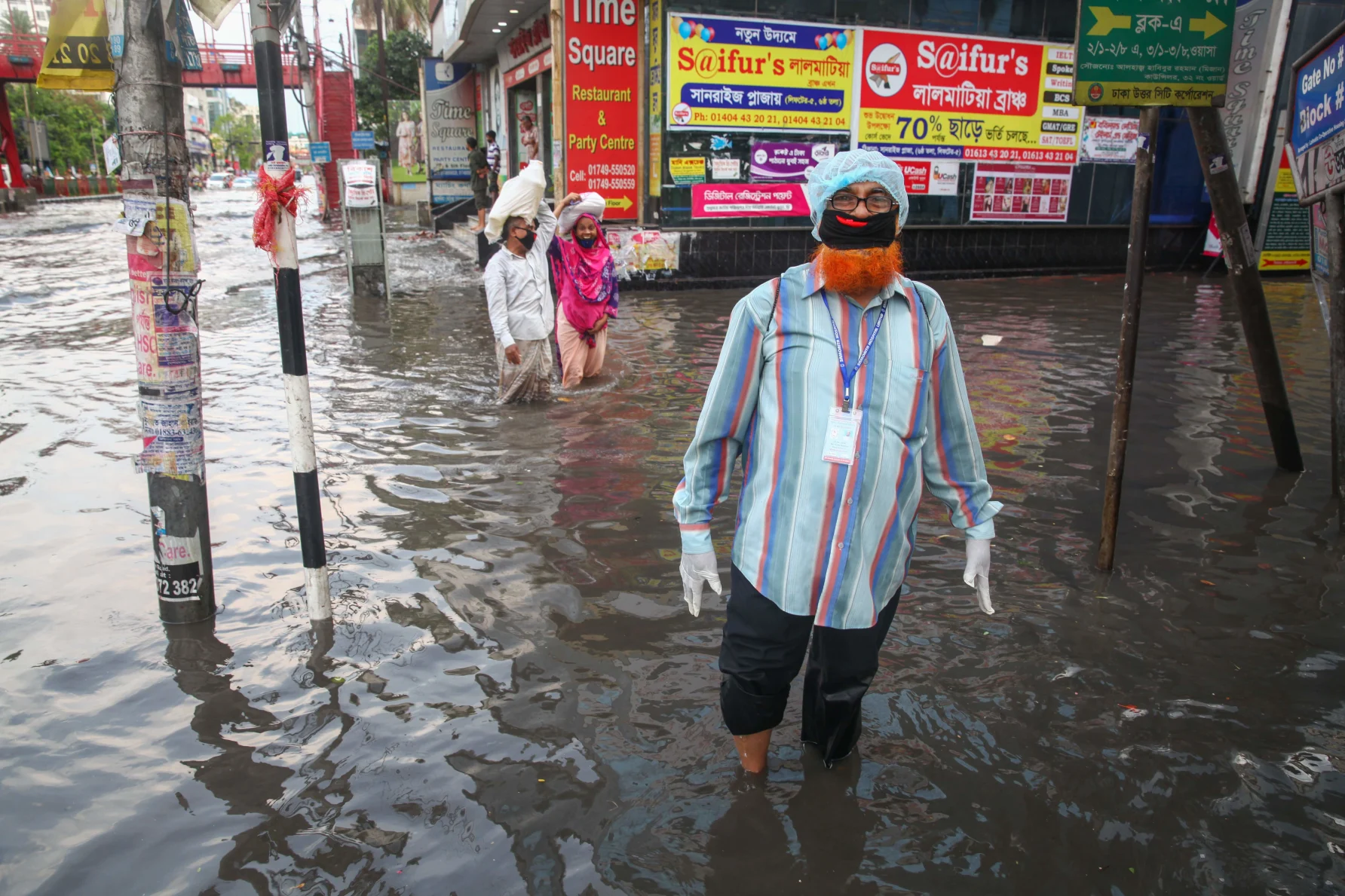 People wading through flood waters in India