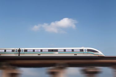 A high-speed train travelling against a blue sky