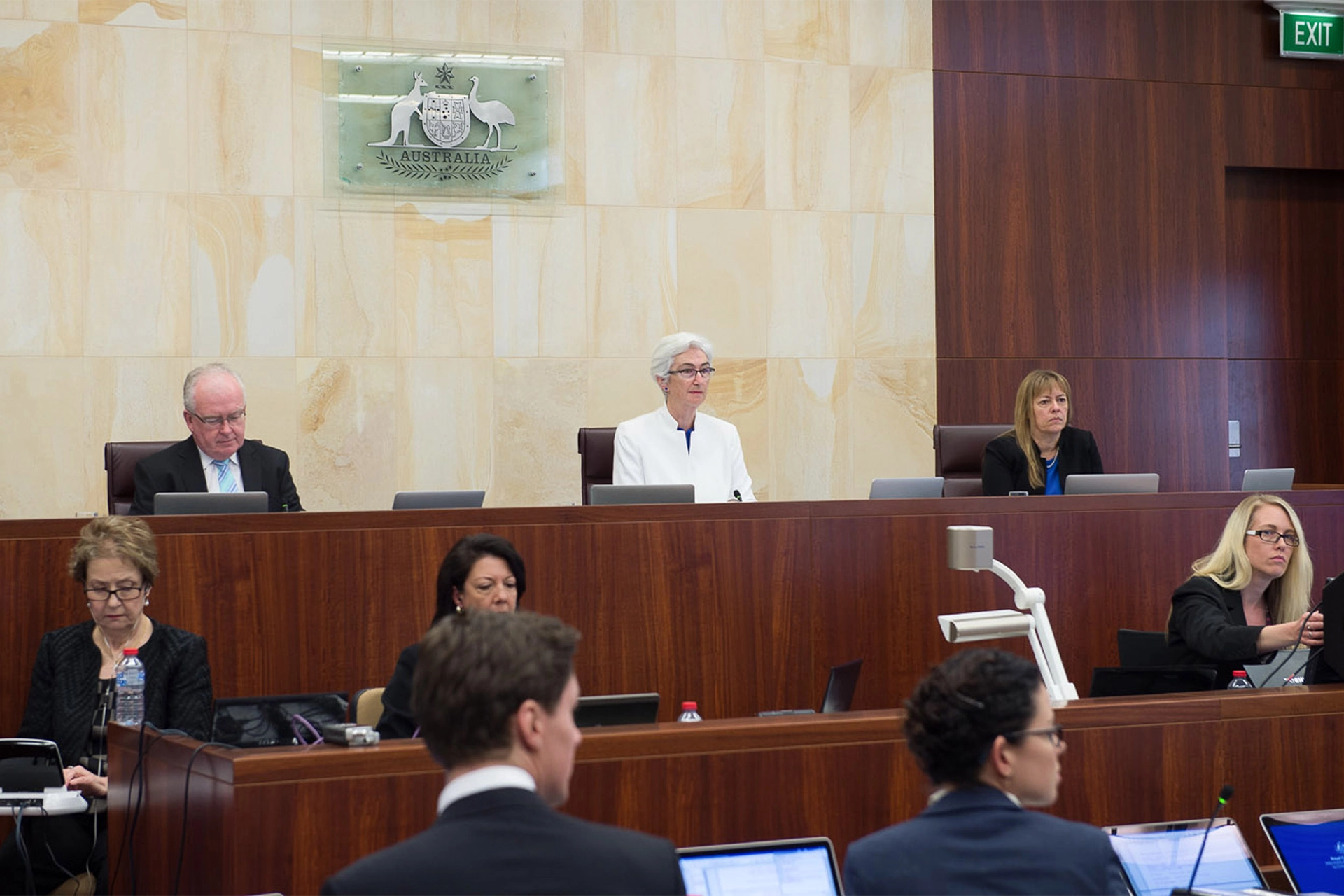 Royal Commission staff sitting at benches during a public hearing