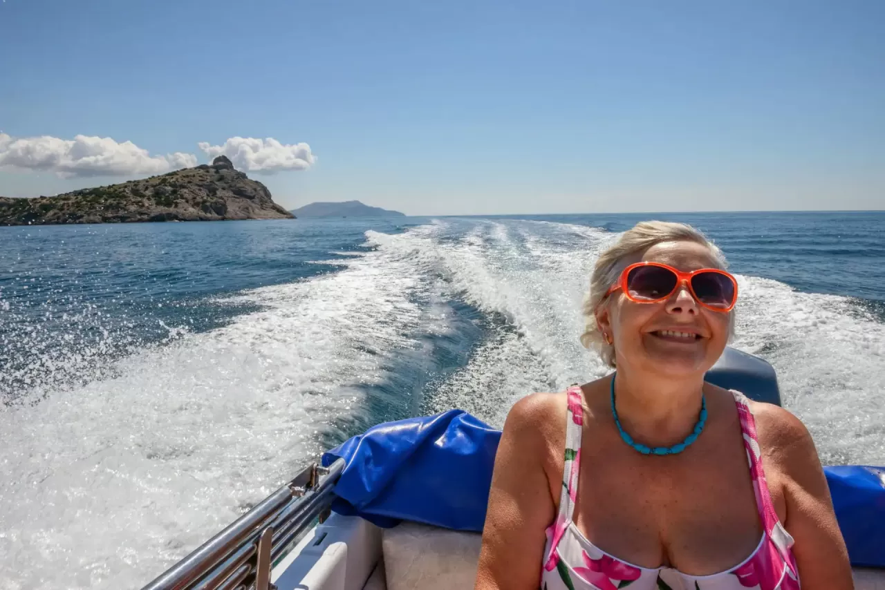 An older woman in a speed boat