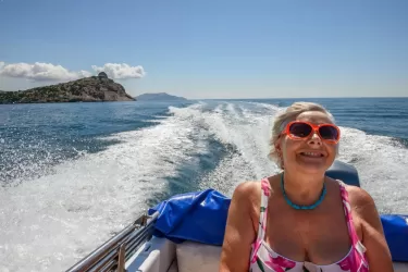 An older woman in a speed boat