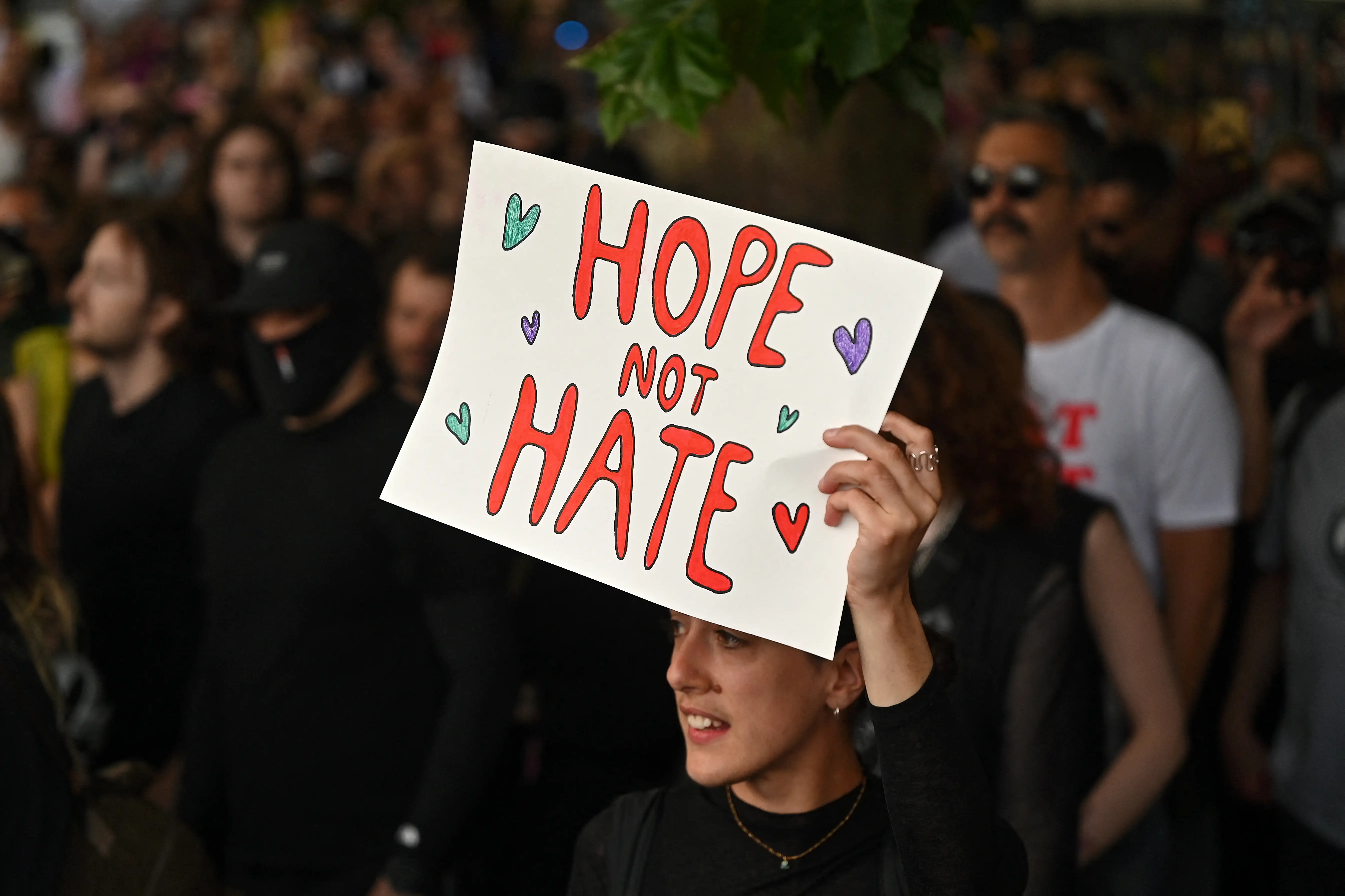 An anti-racism protester holds a placard that reads 'Hope not Hate'