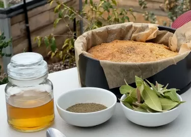 A table displaying a cake and various native ingredients