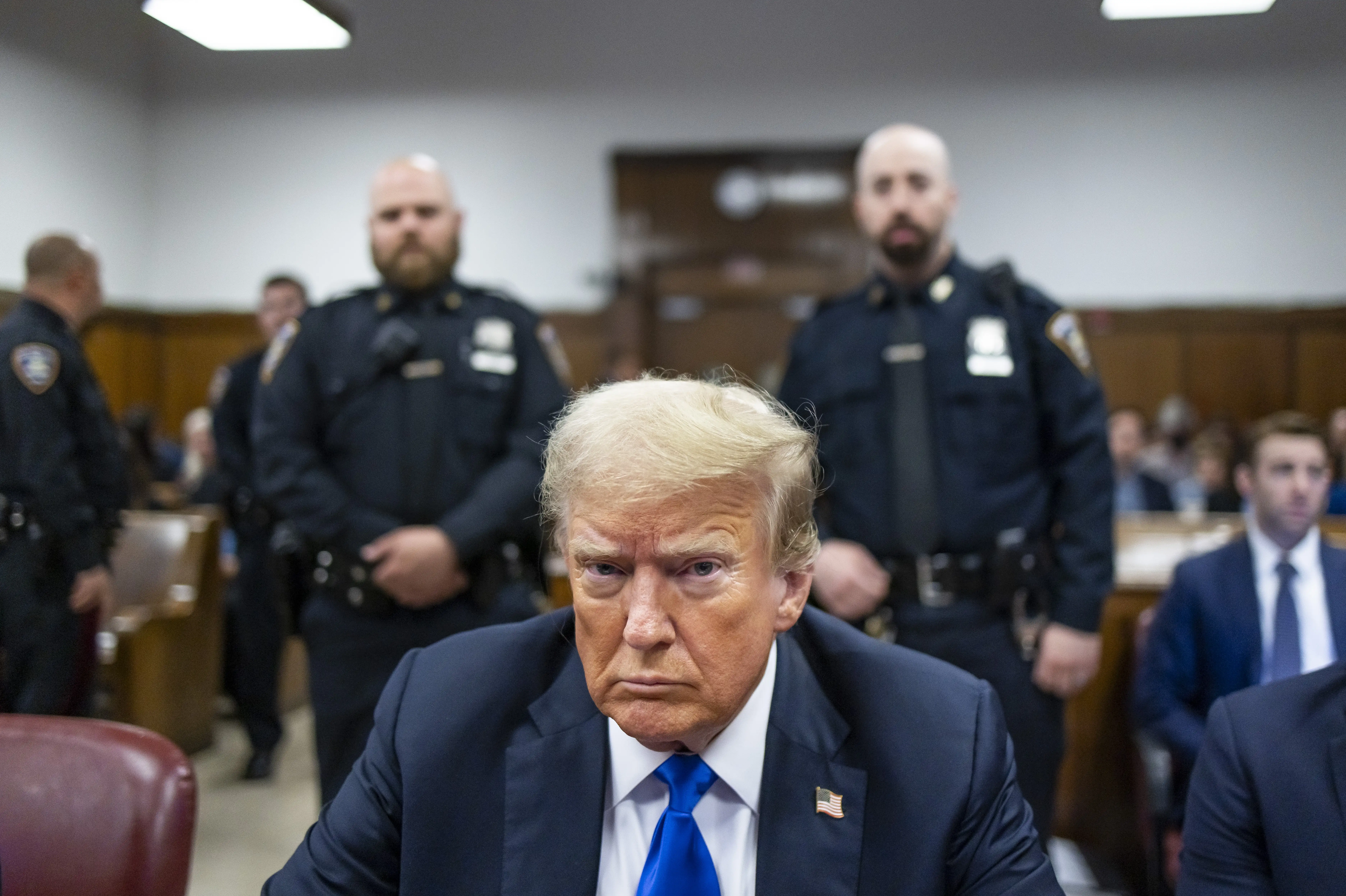 Former U.S. President Donald Trump sits at the defendant's table inside the courthouse