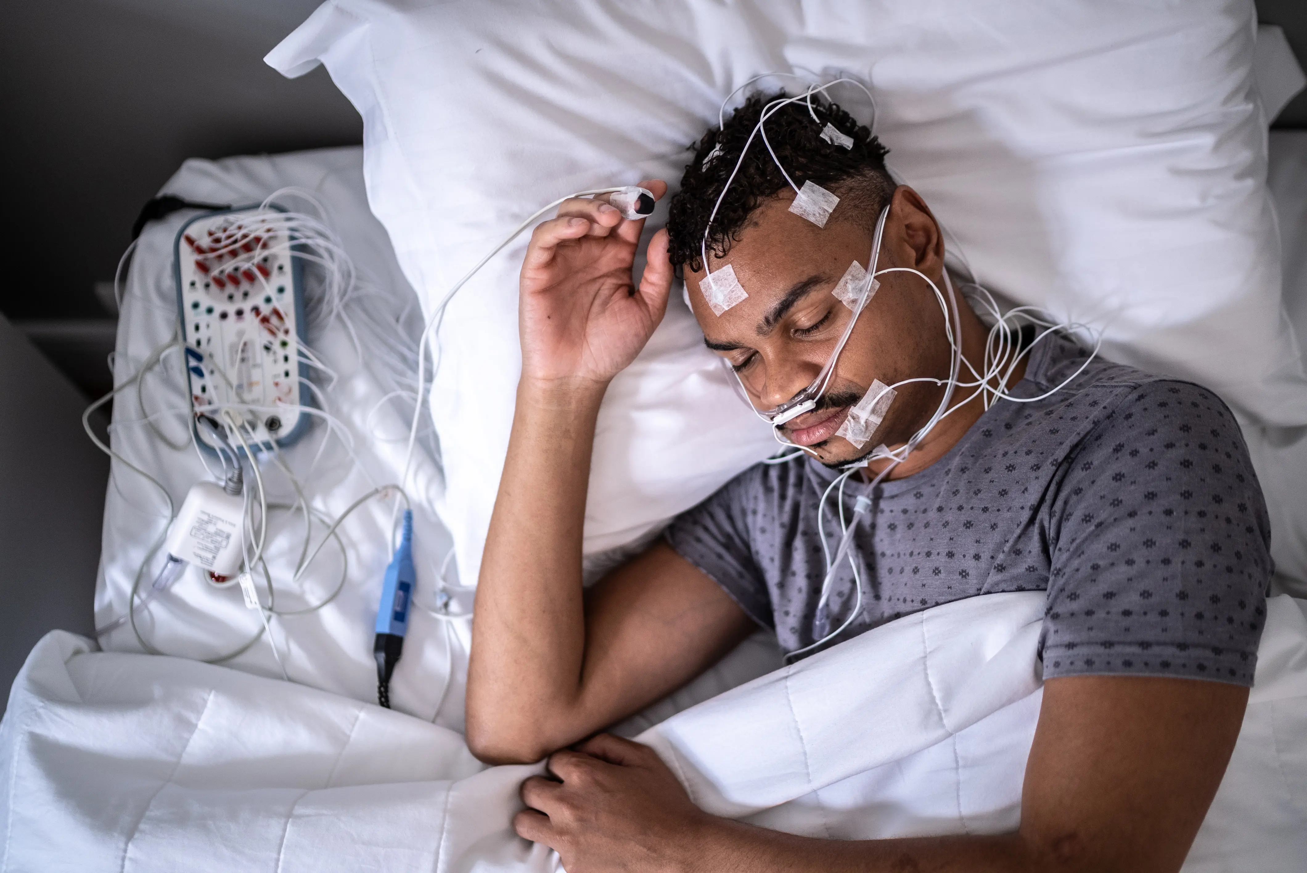 Patient sleeping in a medical clinic doing polysomnography (sleep study)