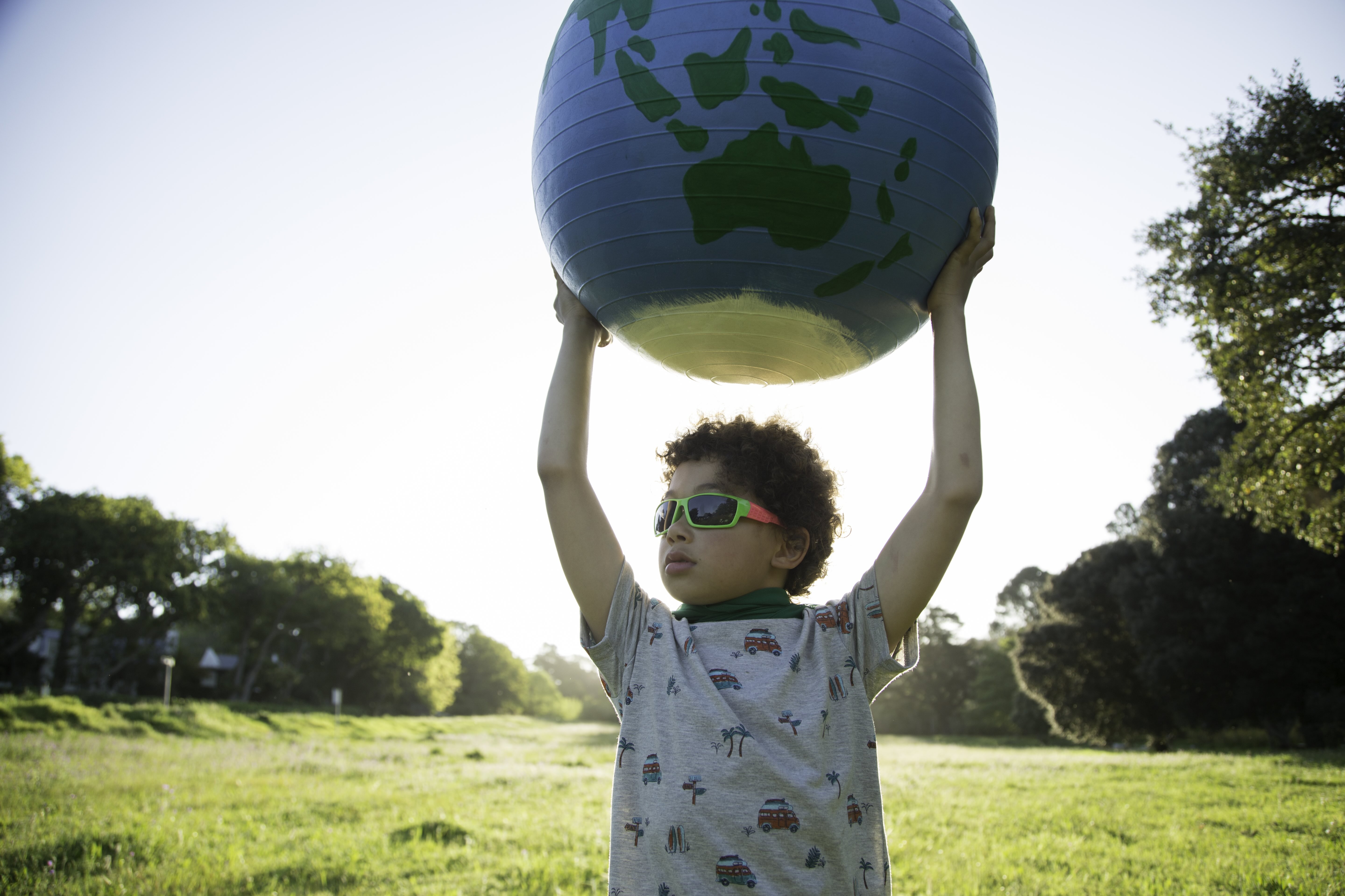 Kid in sunnies with globe