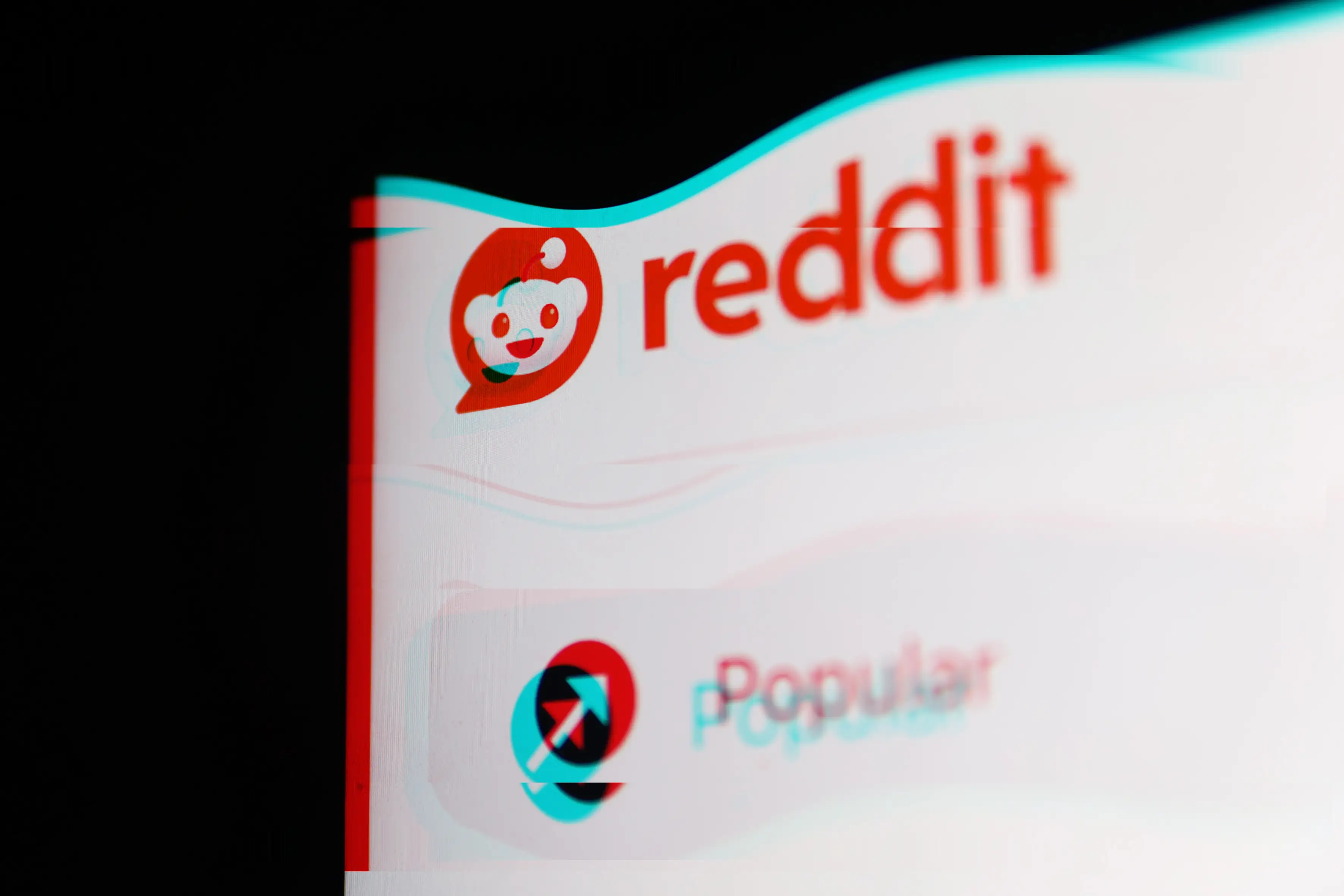 The Reddit logo on a distorted screen