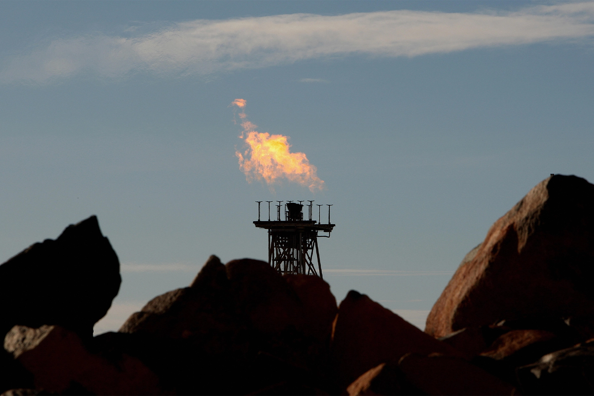 A metal platform with flames from gas burn off